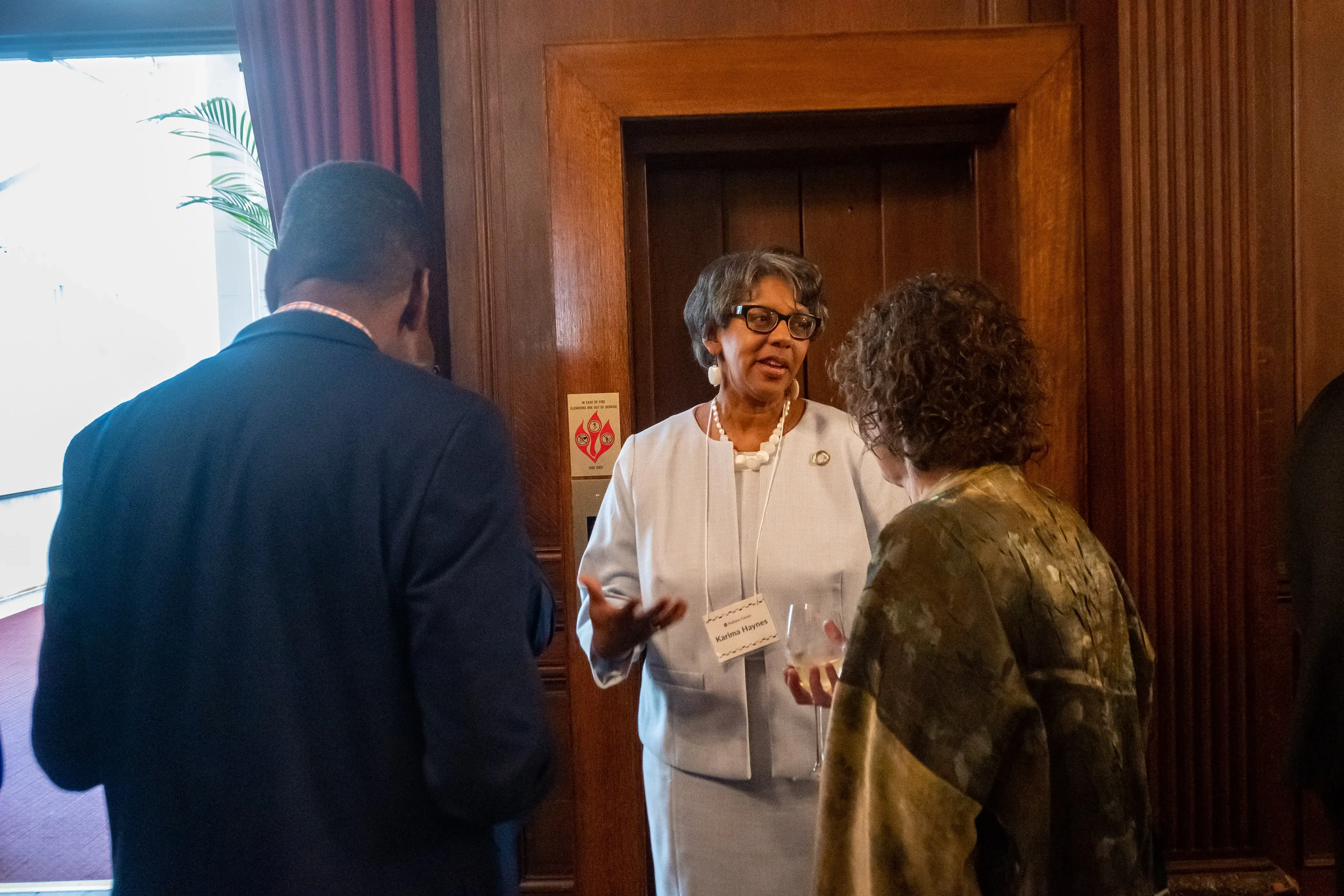 Karima Haynes speaks with fellow attendees at the farewell dinner