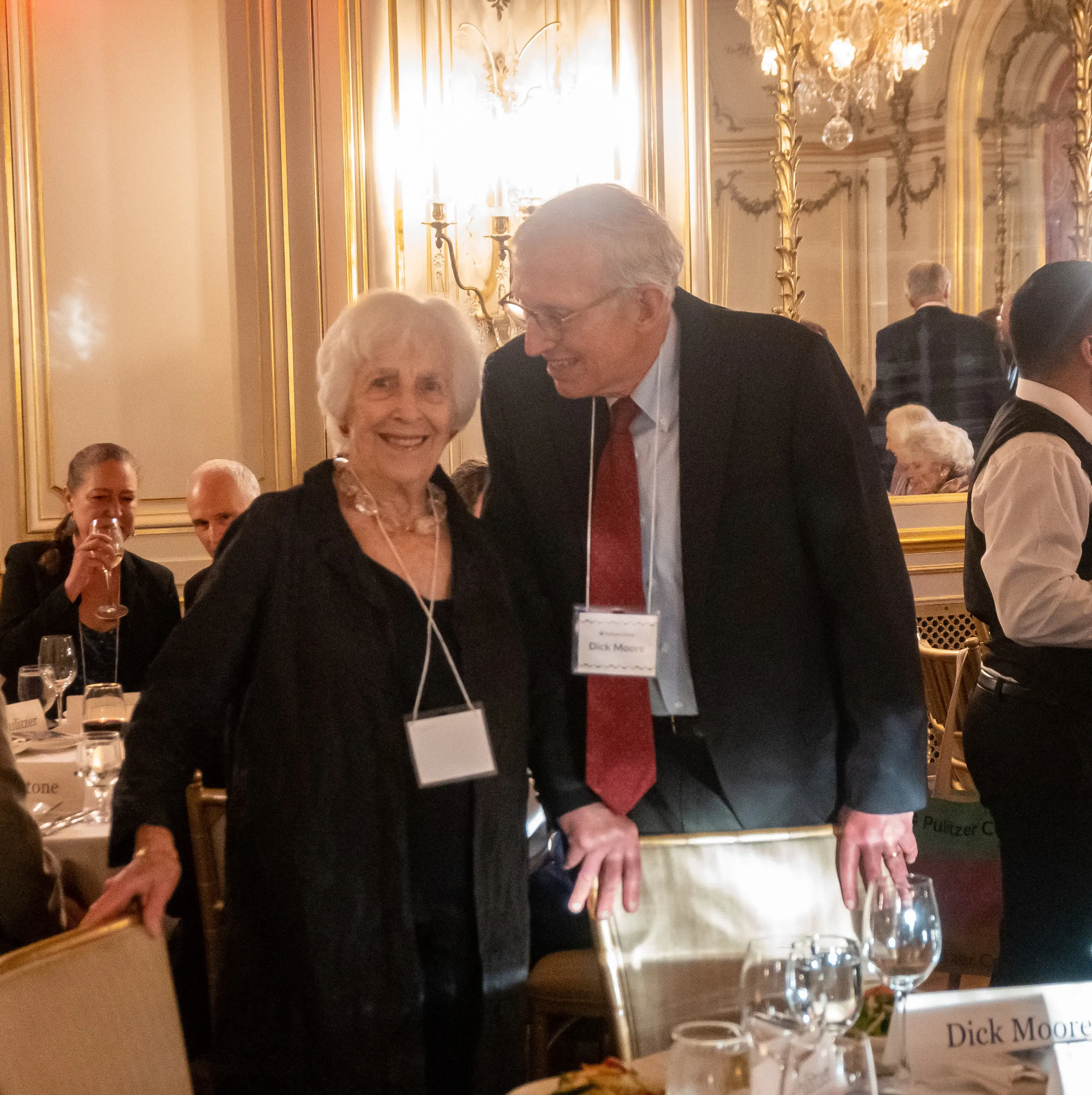 Dick Moore and Emmy Pulitzer pose together at dinner