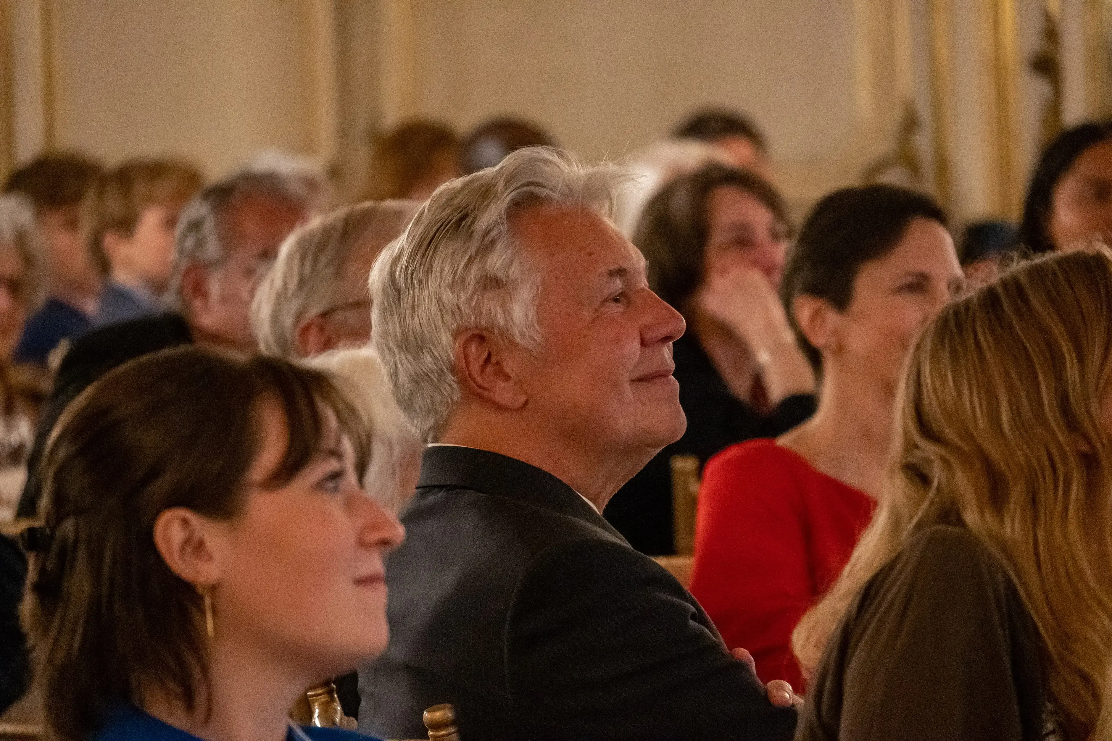 Jon Sawyer looks on with a smile as Emmy Pulitzer makes her farewell address 