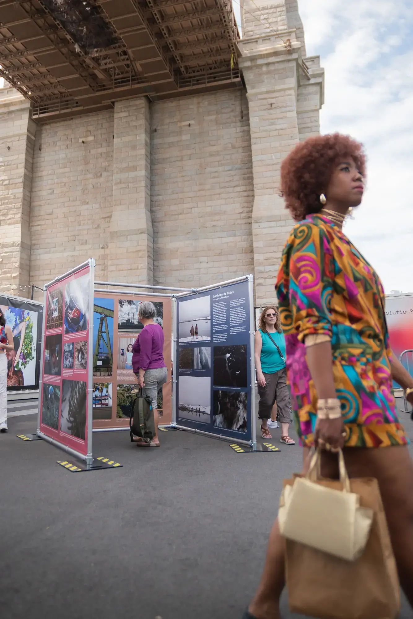 Visitors engage with Pulitzer Center-produced photography exhibit "Eyewitness: The Shadows of Climate Change"