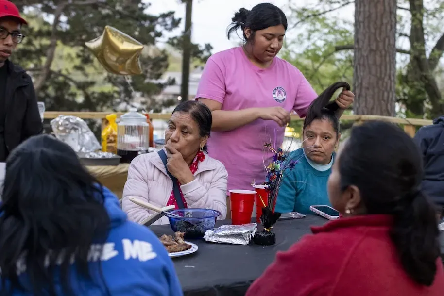 A family celebrating at an outdoor table