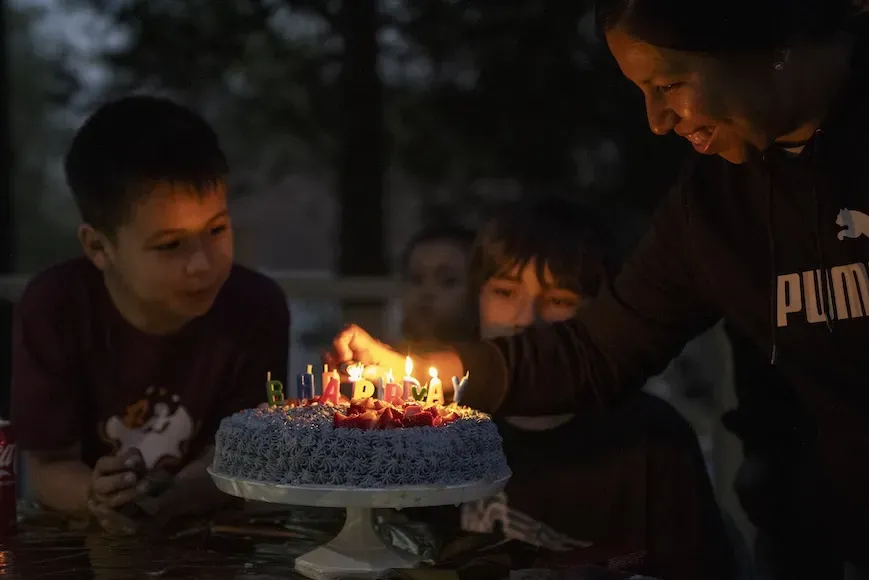 A child waits to blow out birthday candles