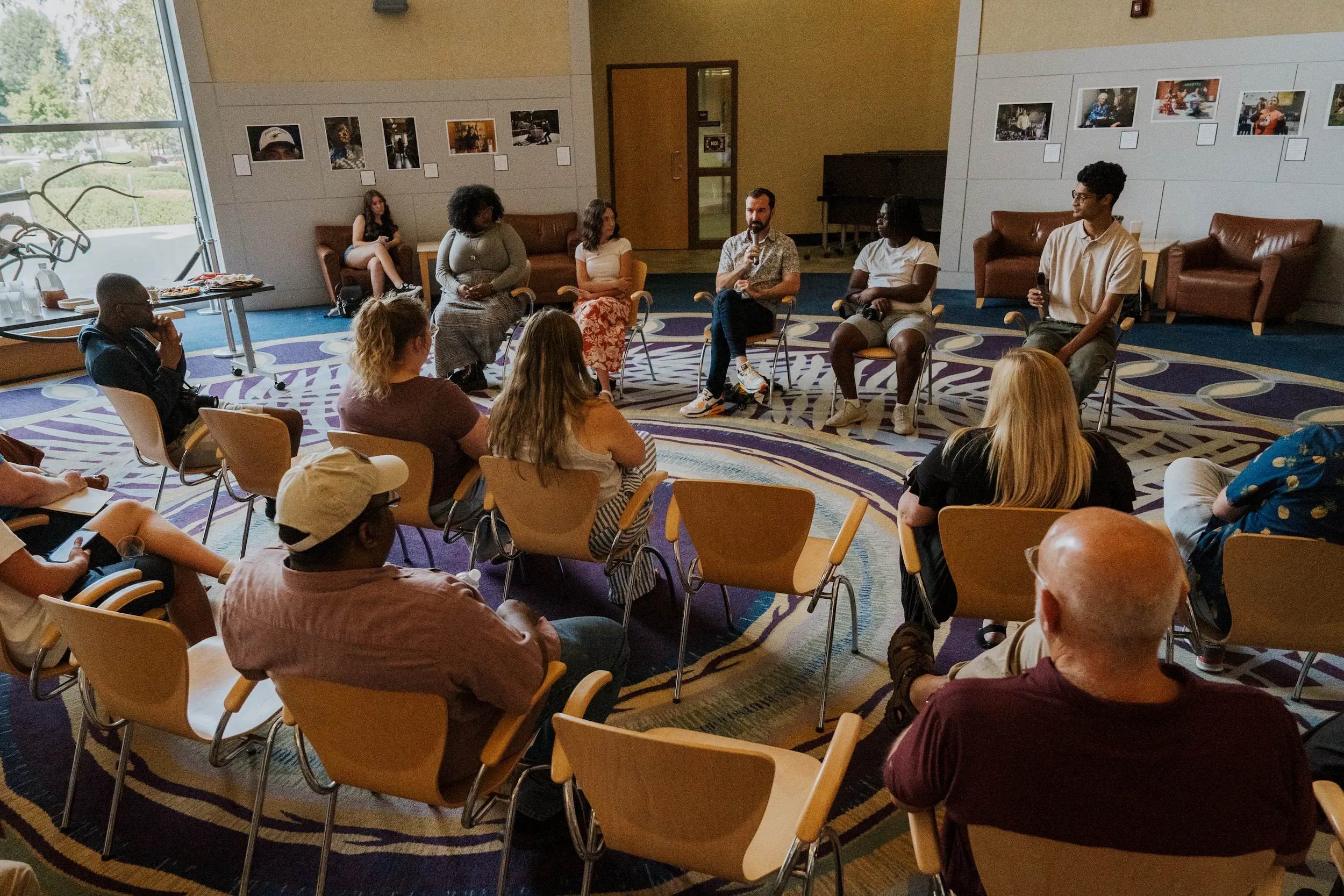 A small audience of people watching a panel discussion