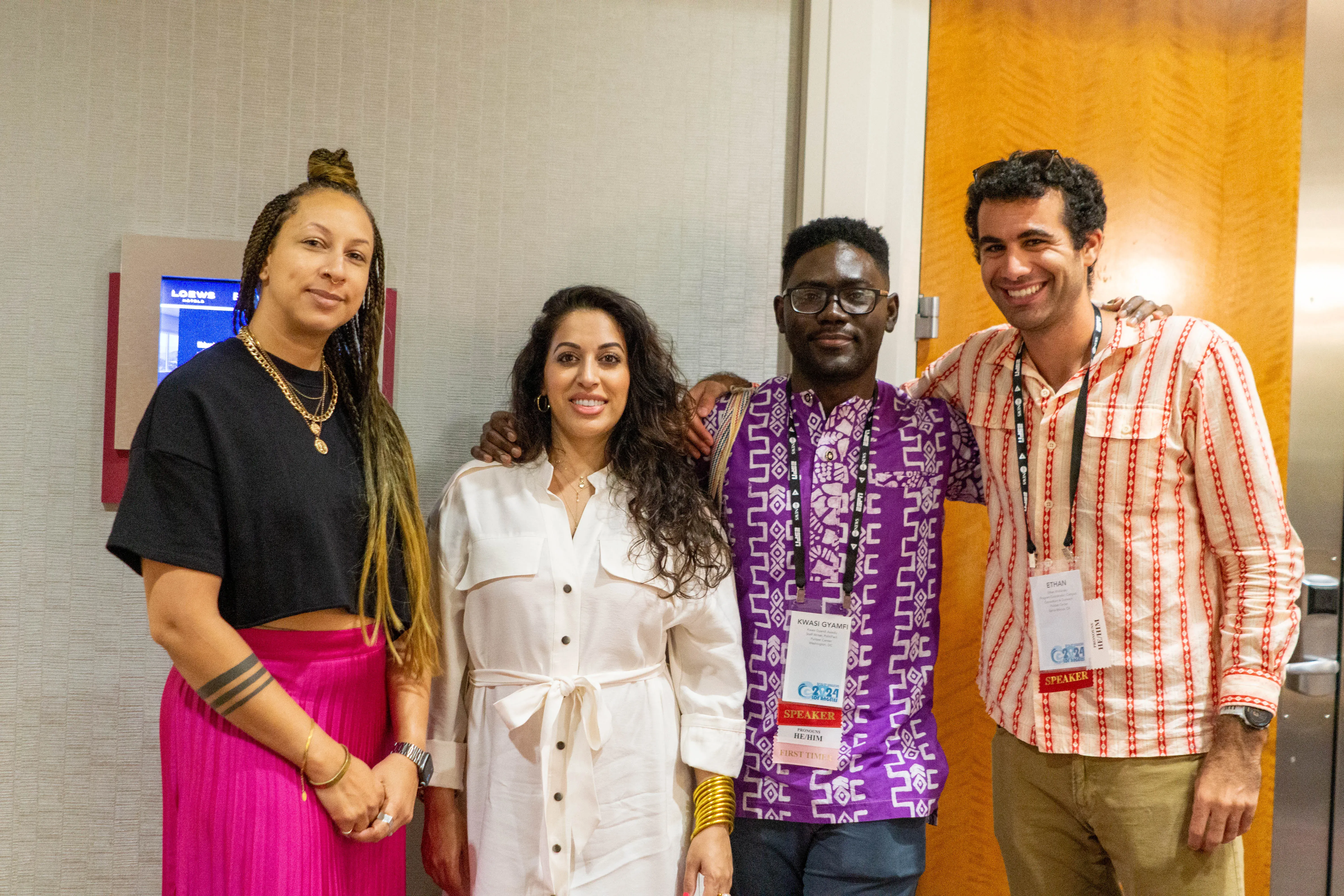 four people pose at NLGJA conference 2024