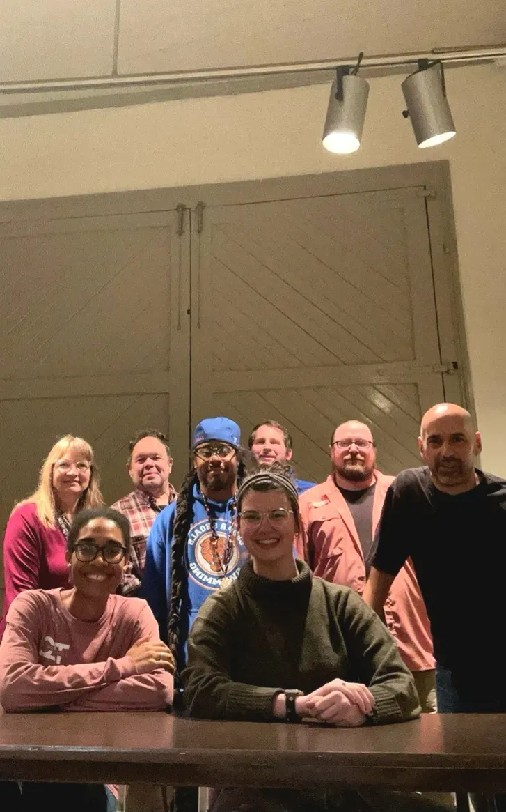 Seven educators gather together and face the camera. They are of varying ages, genders and races. 