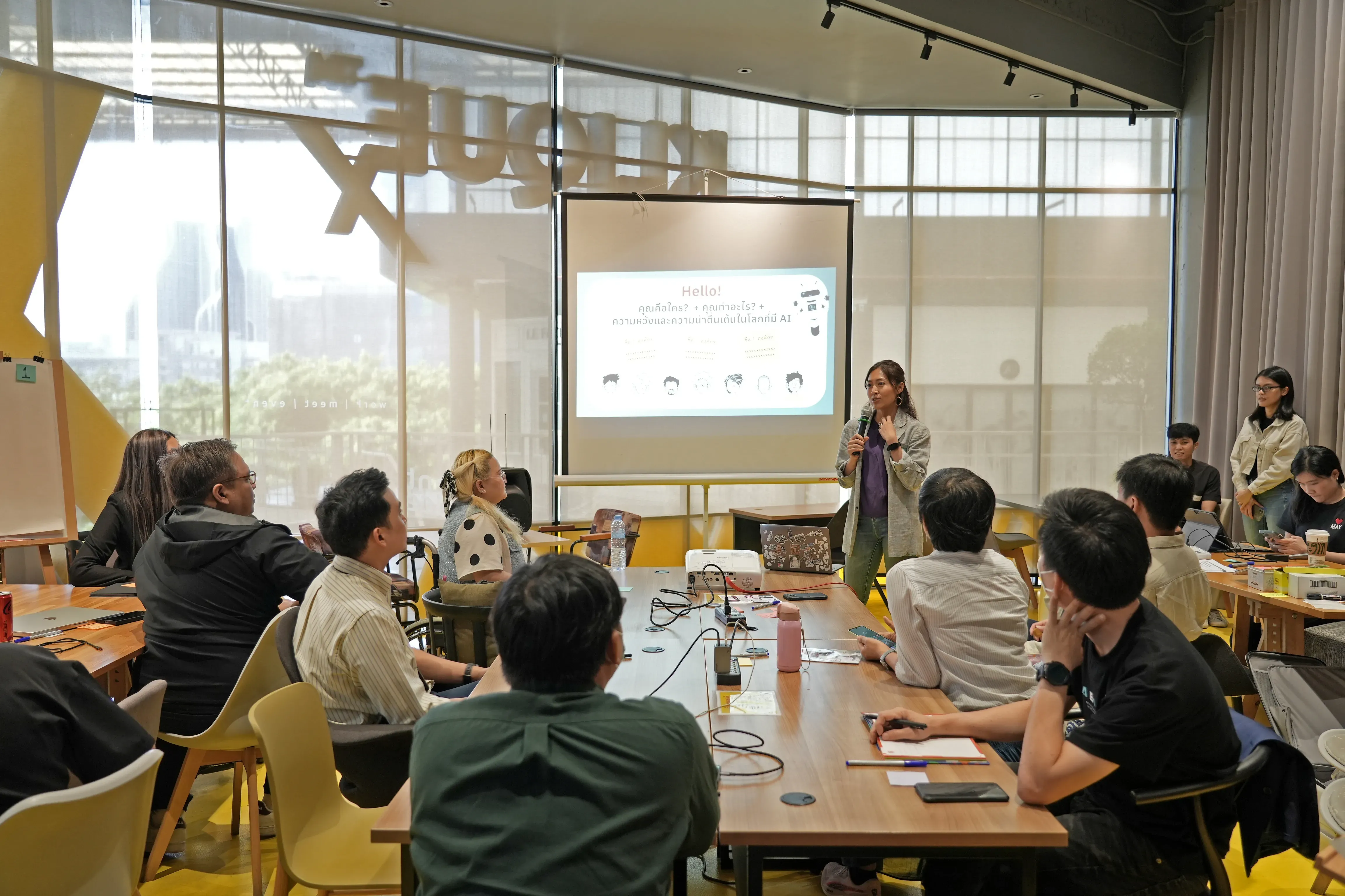a speaker presents to a room of people