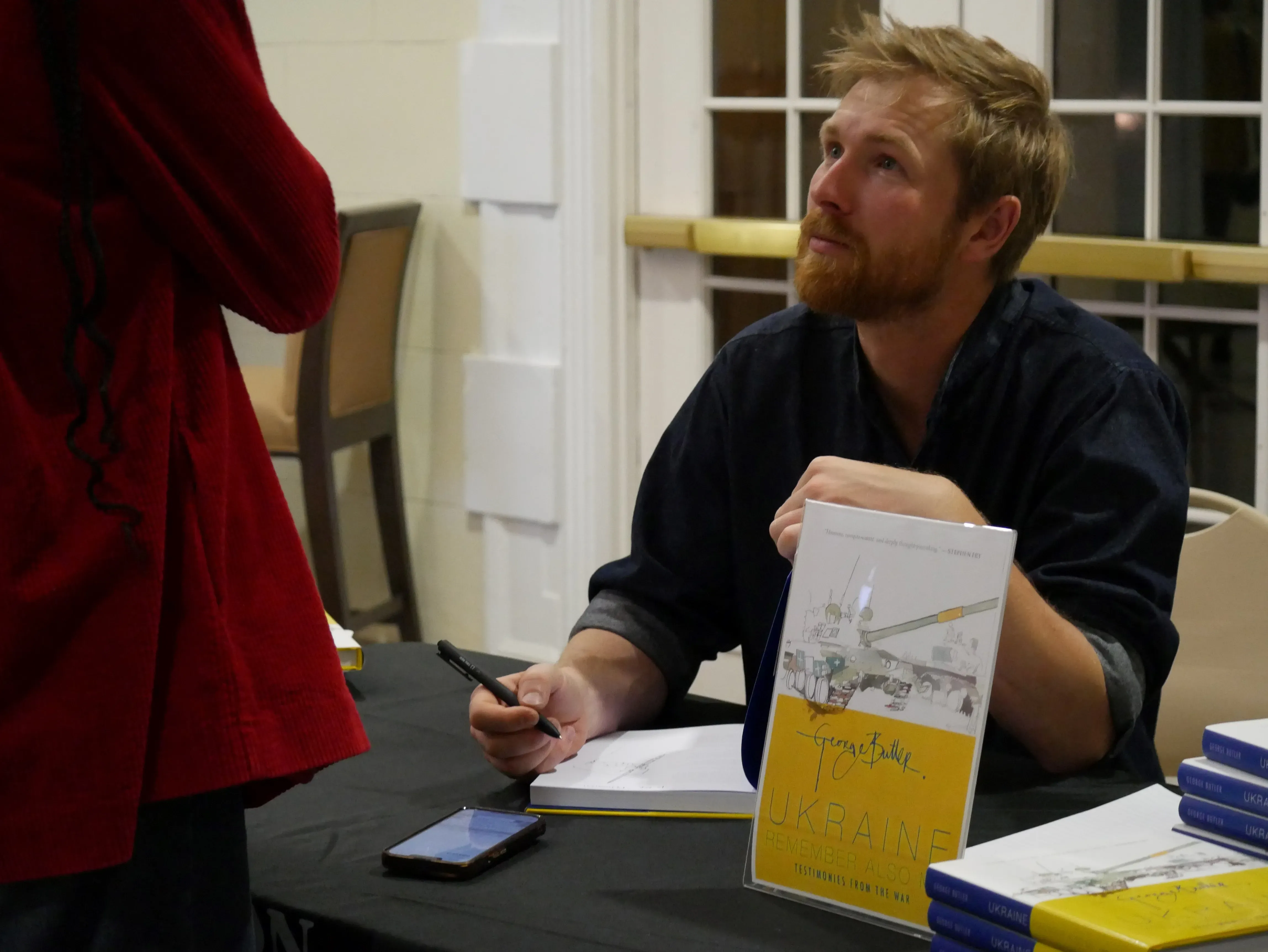 Illustrator George Butler signs copies of his new book,  Ukraine: Remember Also Me. 