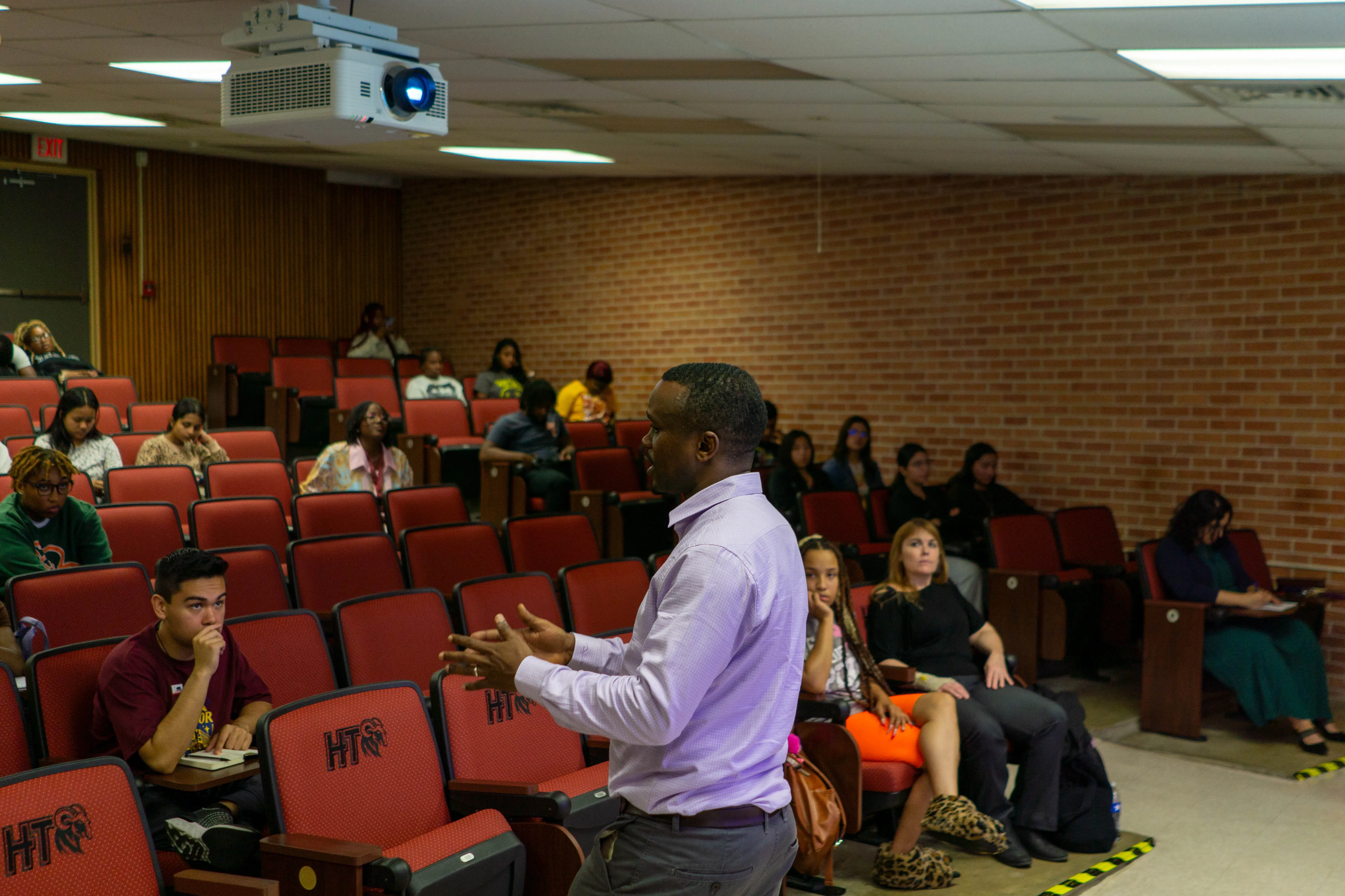 A man speaks to an audience of students