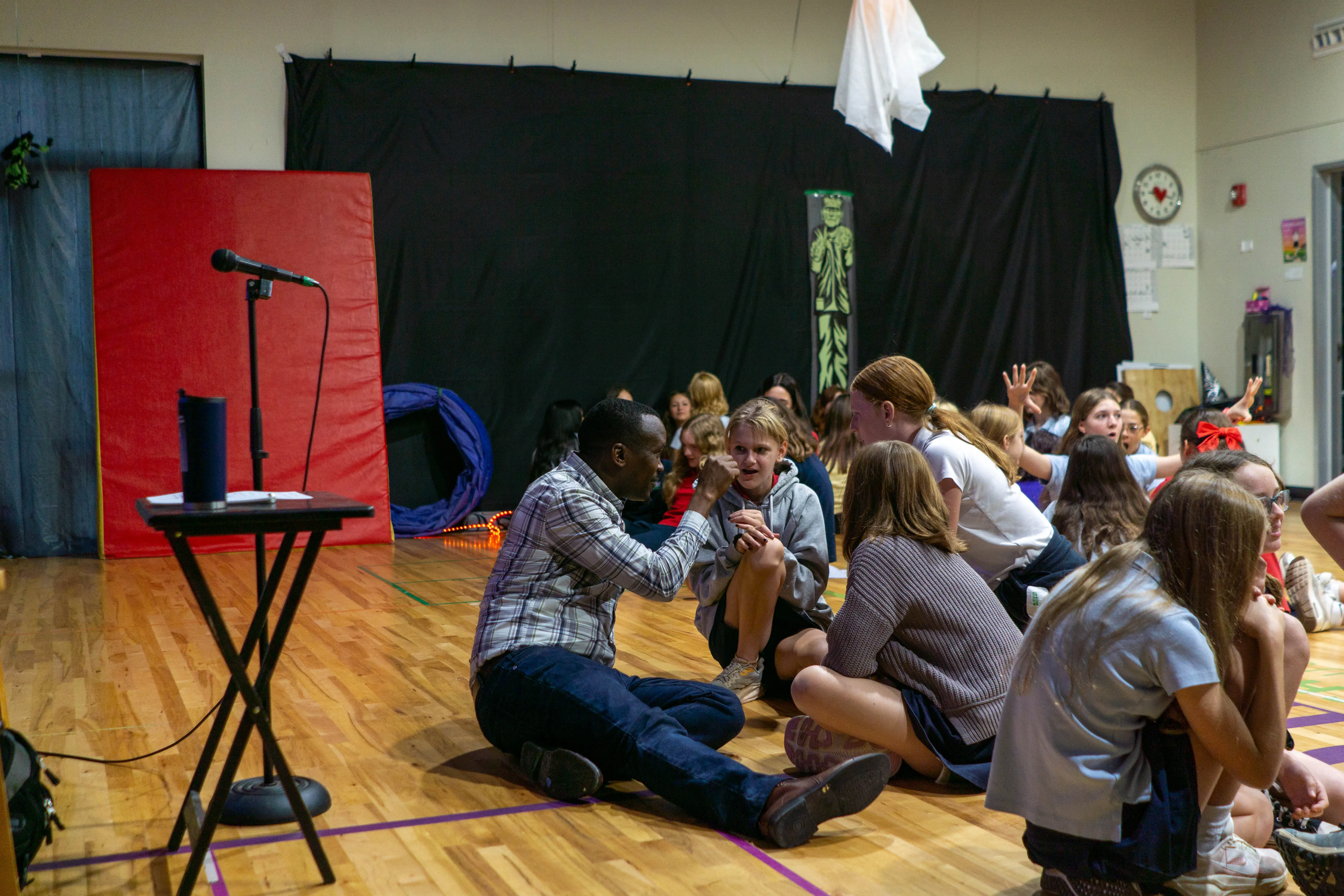 Man speaking with young students.
