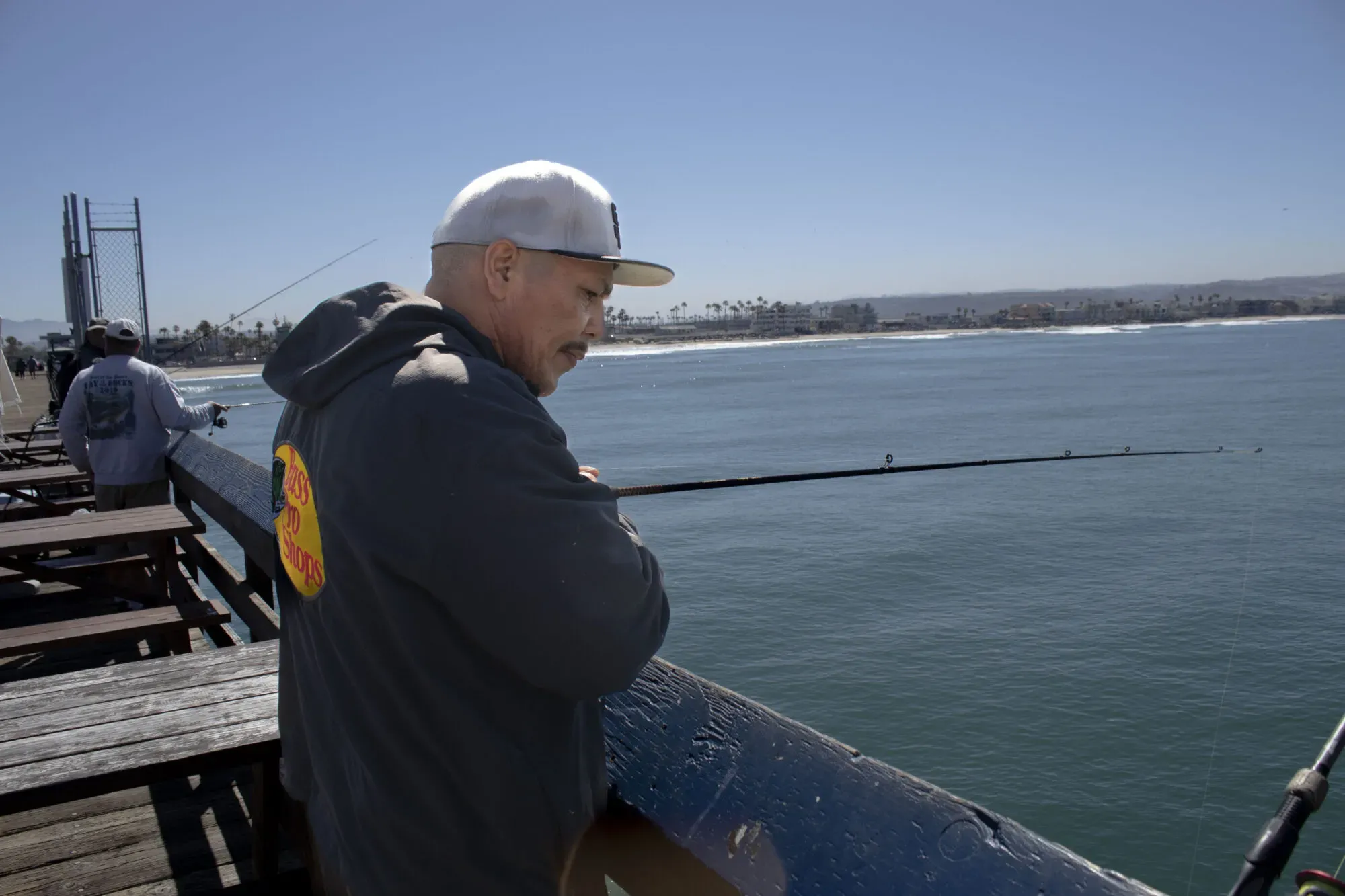 Imperial Beach resident and fisherman Jorge Arrollo looks over the water as he casts his line over the local pier on April 2, 2024. He says that the water quality has significantly decimated fish populations in Imperial Beach.