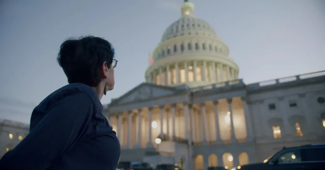 Public defender Heather Shaner looks up at the U.S. Capitol building.