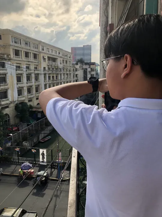 student looks out the window at public art exhibit