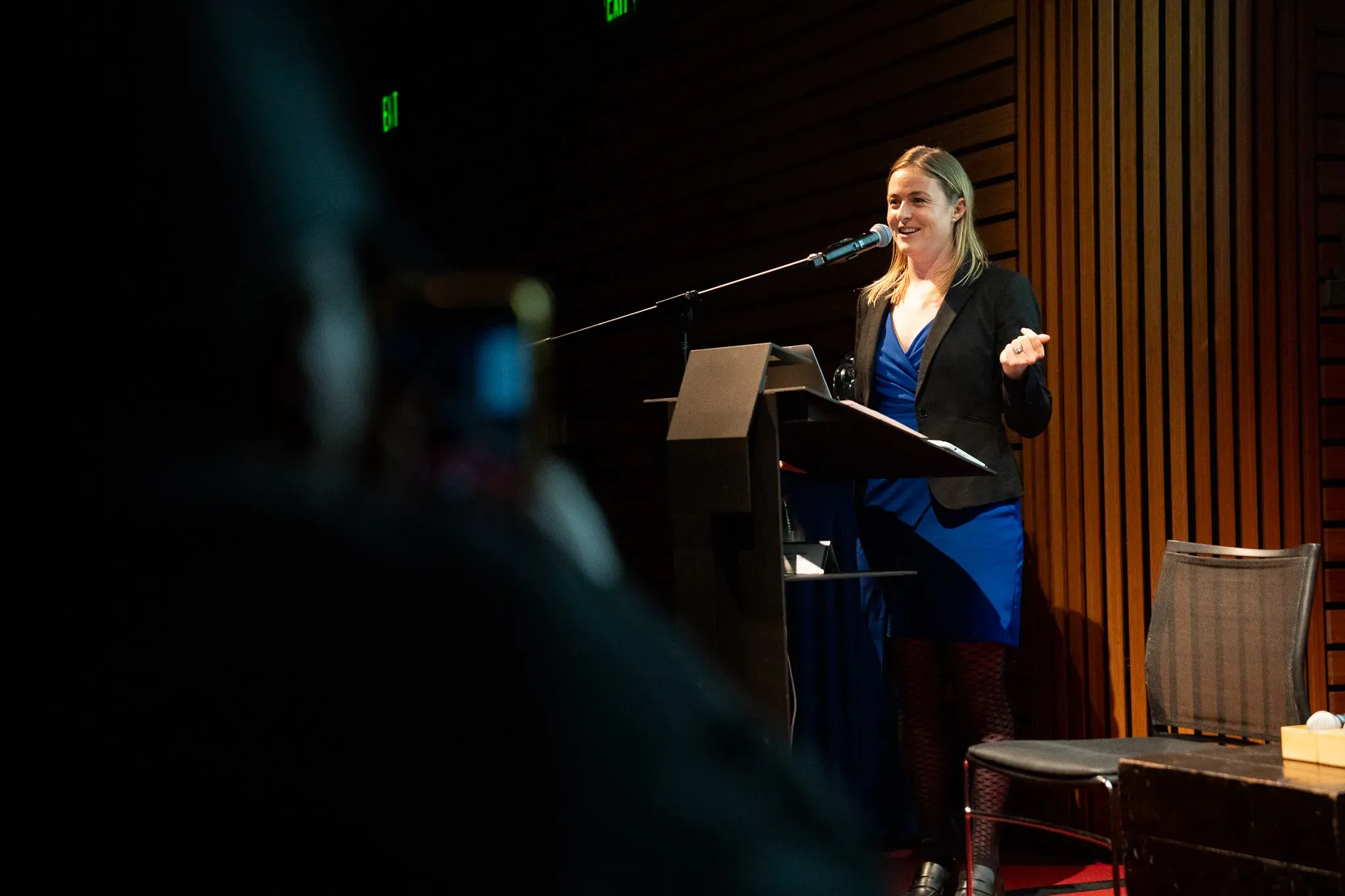 Woman presents at podium mic