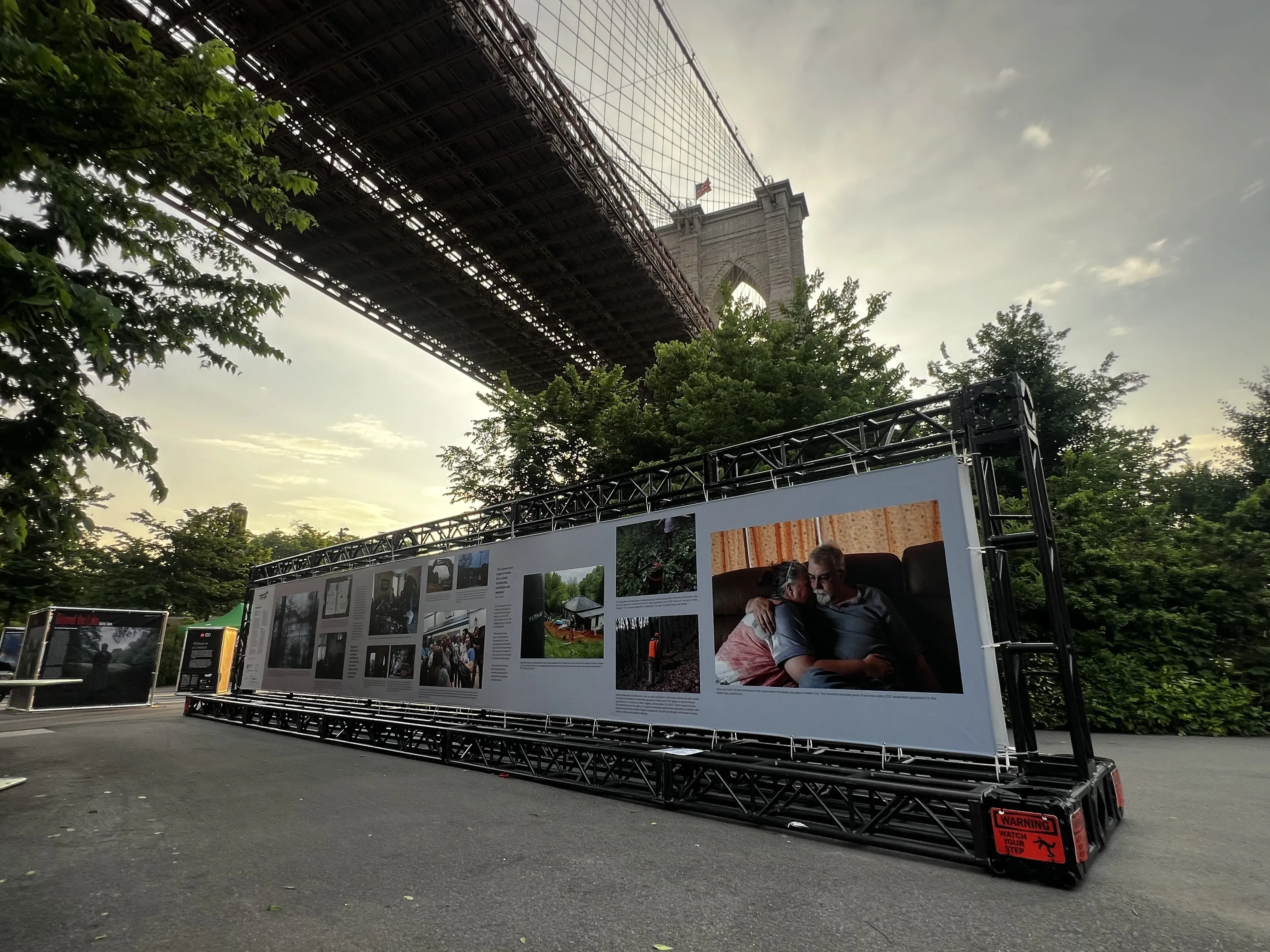 "Hollowed Out" banner on display under the Brooklyn Bridge.