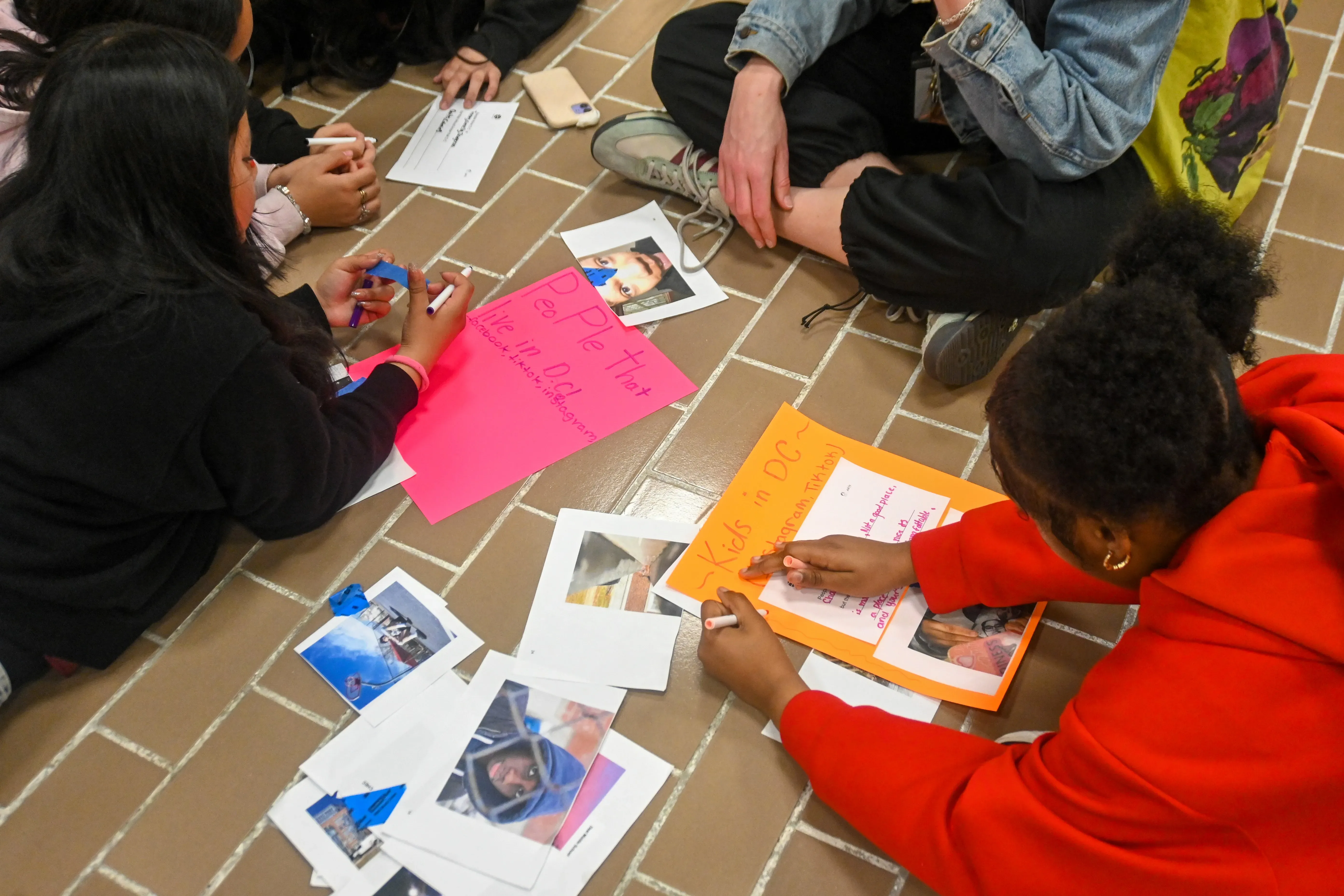 Students collaborate on making posters with photographs