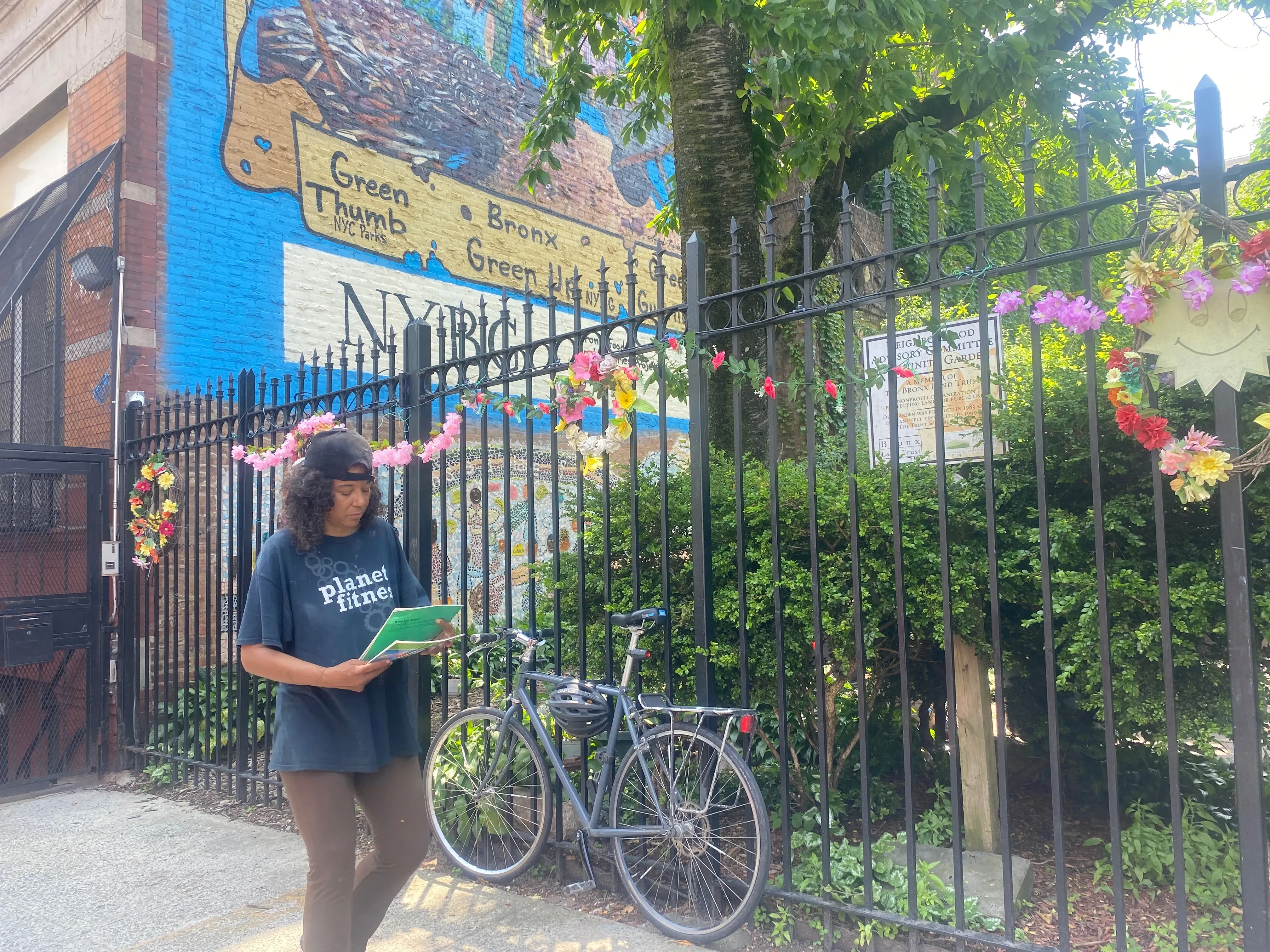 Woman walks in front of community garden