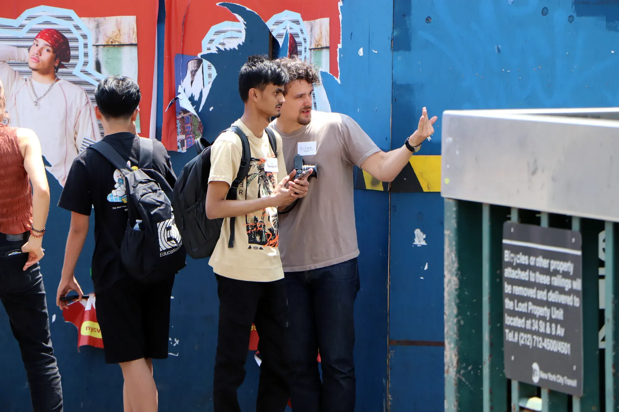 Two people stand and look off frame
