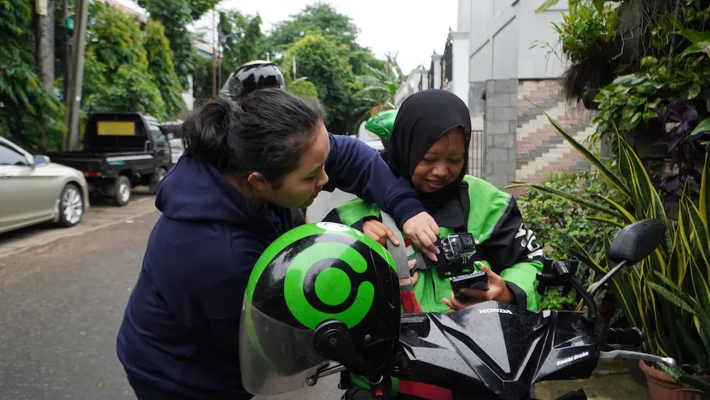 Sherlina straps an action camera onto the source in Jagakarsa, South Jakarta, on December 6th, 2024.