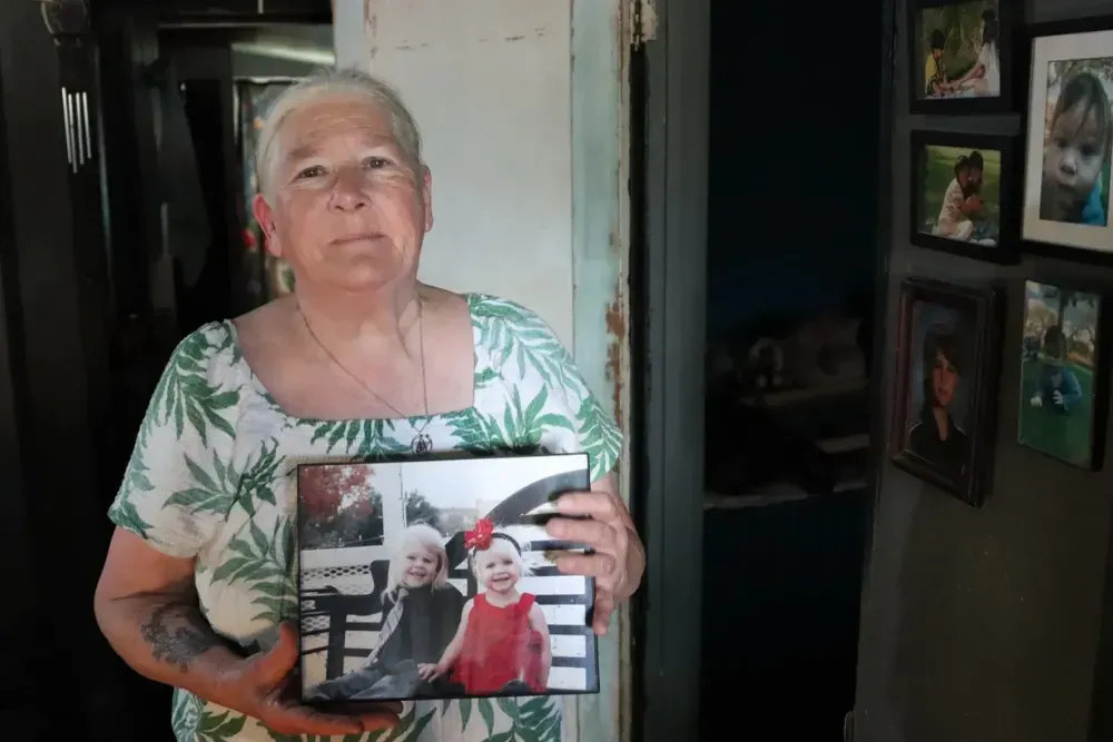 Susie Wilson stands with a photo of her granddaughter HardiQuinn Hill, who died despite calls to the Texas Department of Family and Protective Services from friends, family, and police.