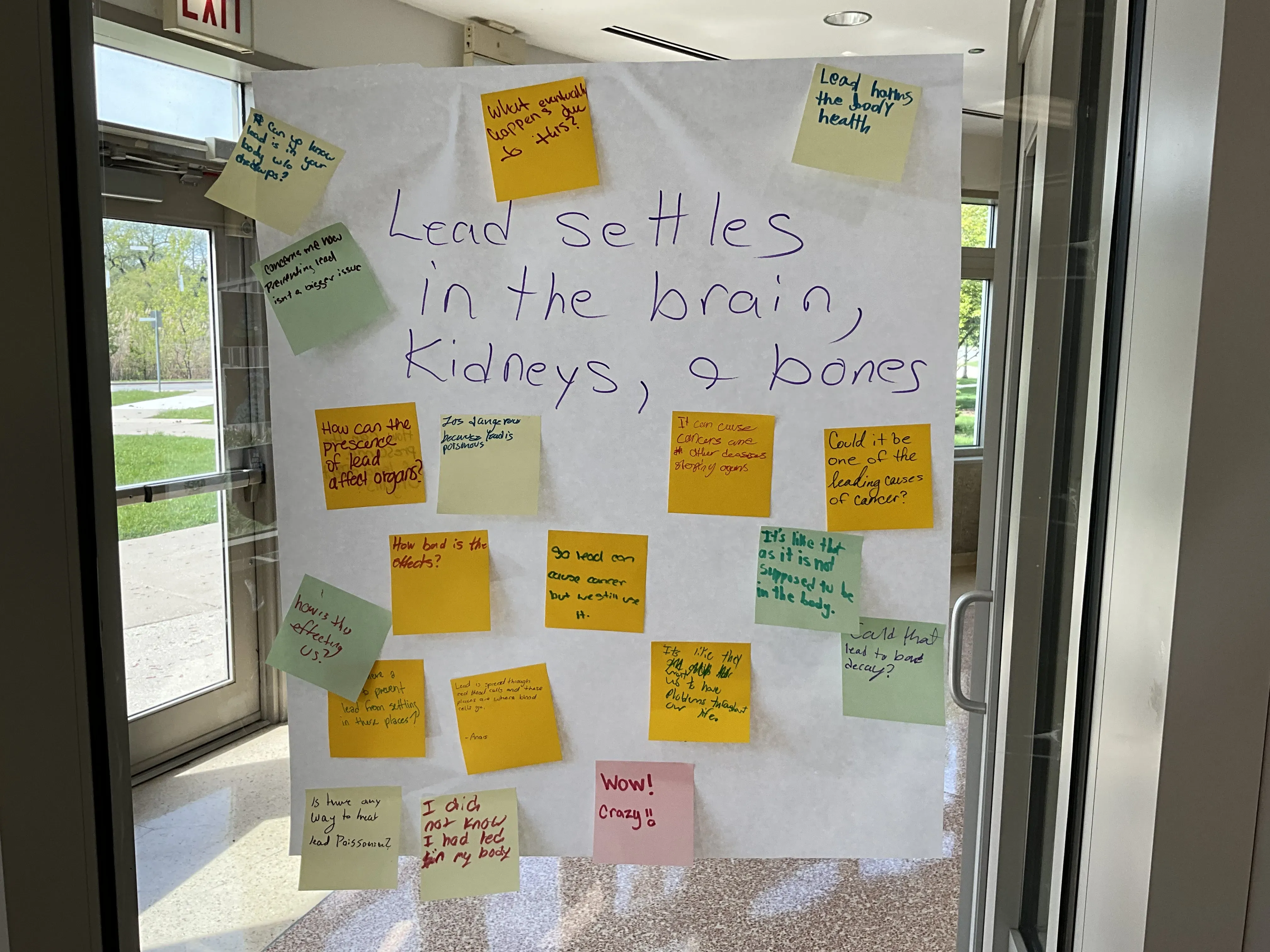 question written on board paper surrounded by post-it note commentary