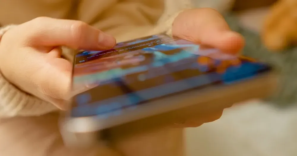 Female hands scroll social media on a smart phone