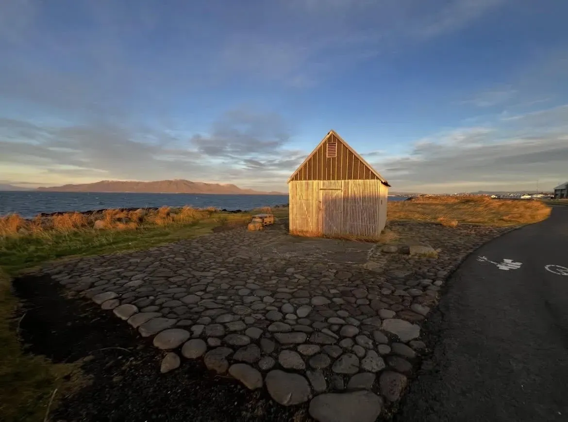 A small wooden house sees the final golden hour light