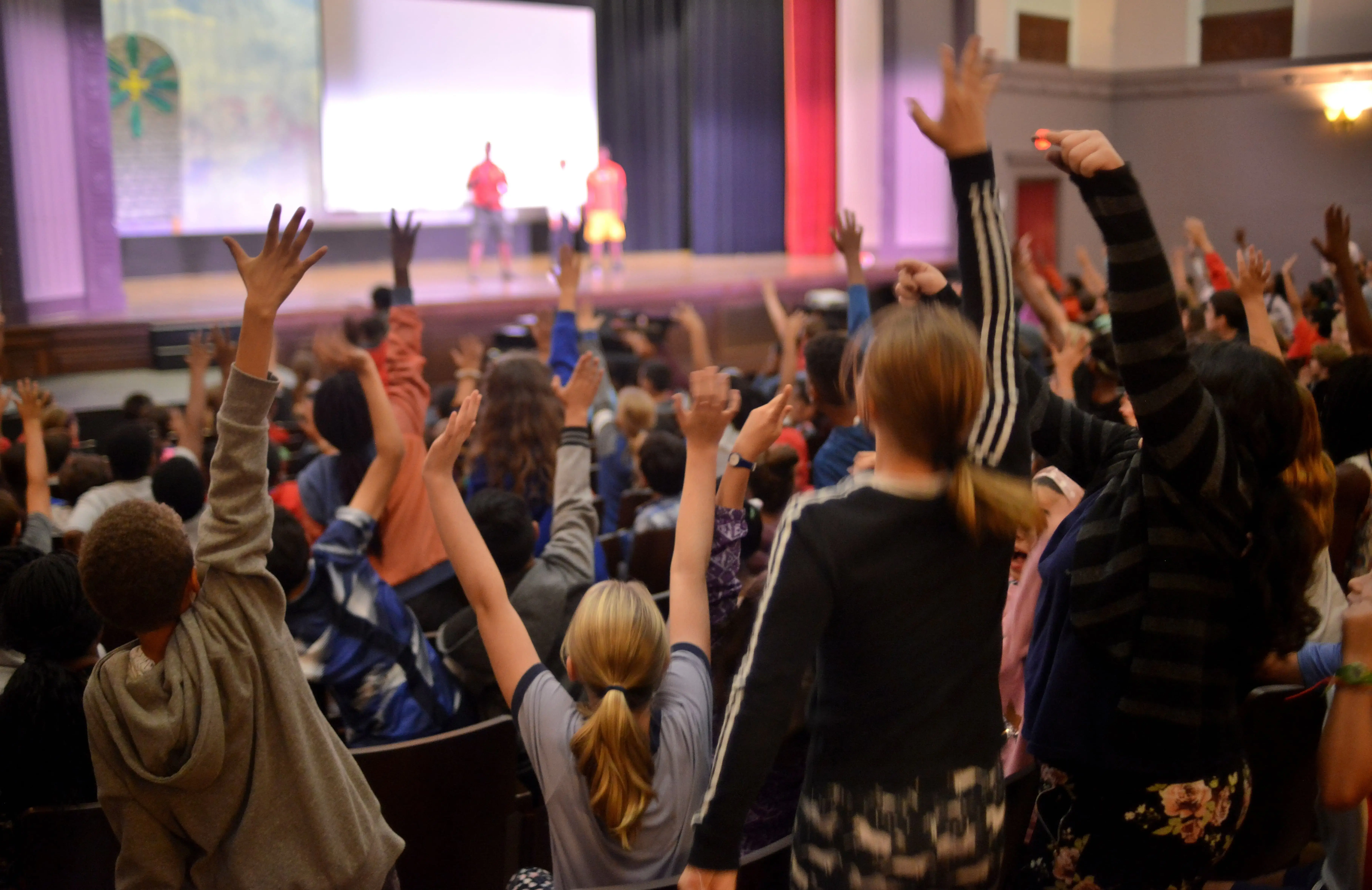 Eager students volunteer to participate in acrobatics onstage. Image by Dermot Tatlow. United States, 2018. Eager students volunteer to participate in acrobatics onstage. Image by Dermot Tatlow. United States, 2018.