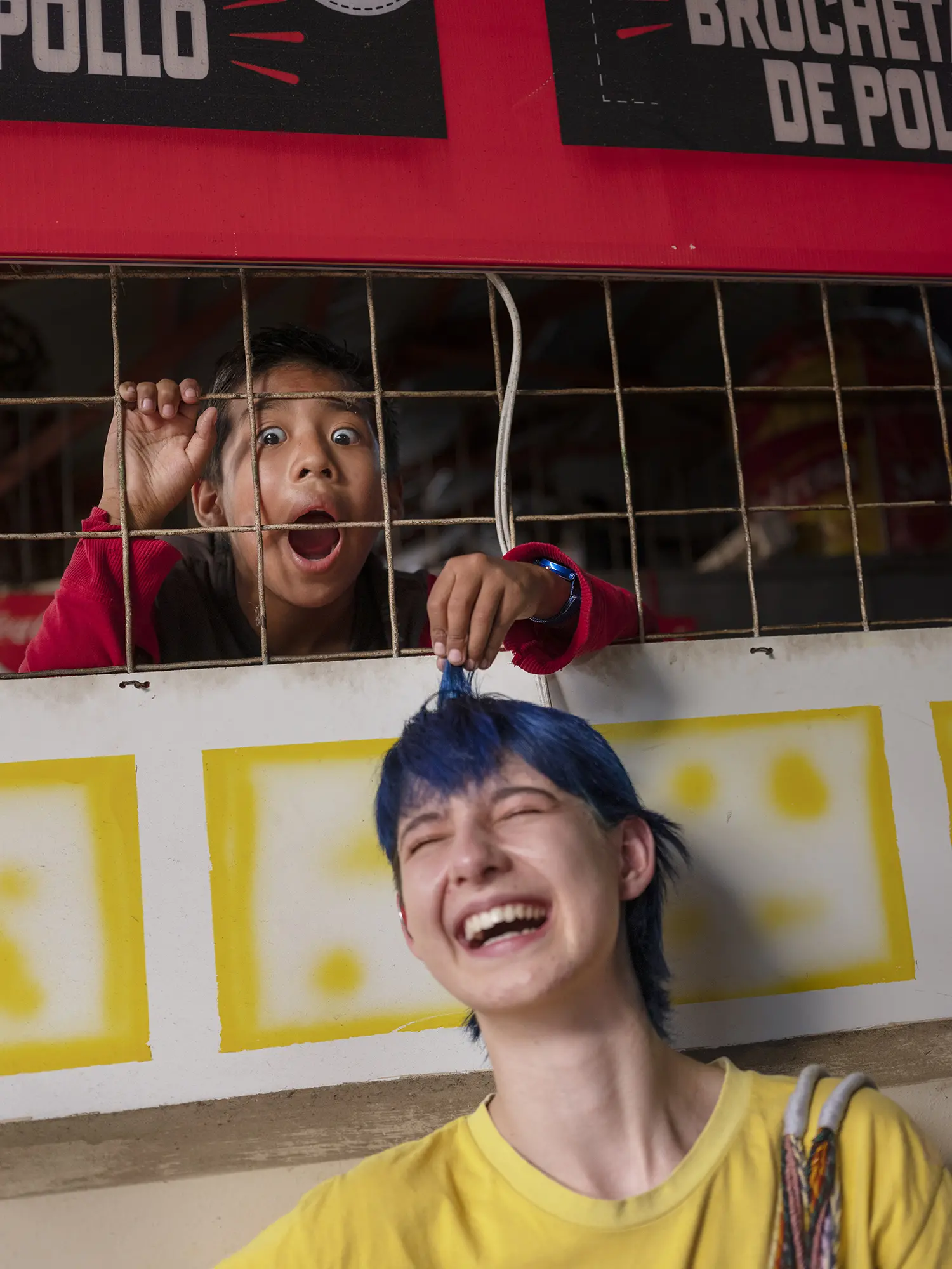 A young girl plays with Tam's hair