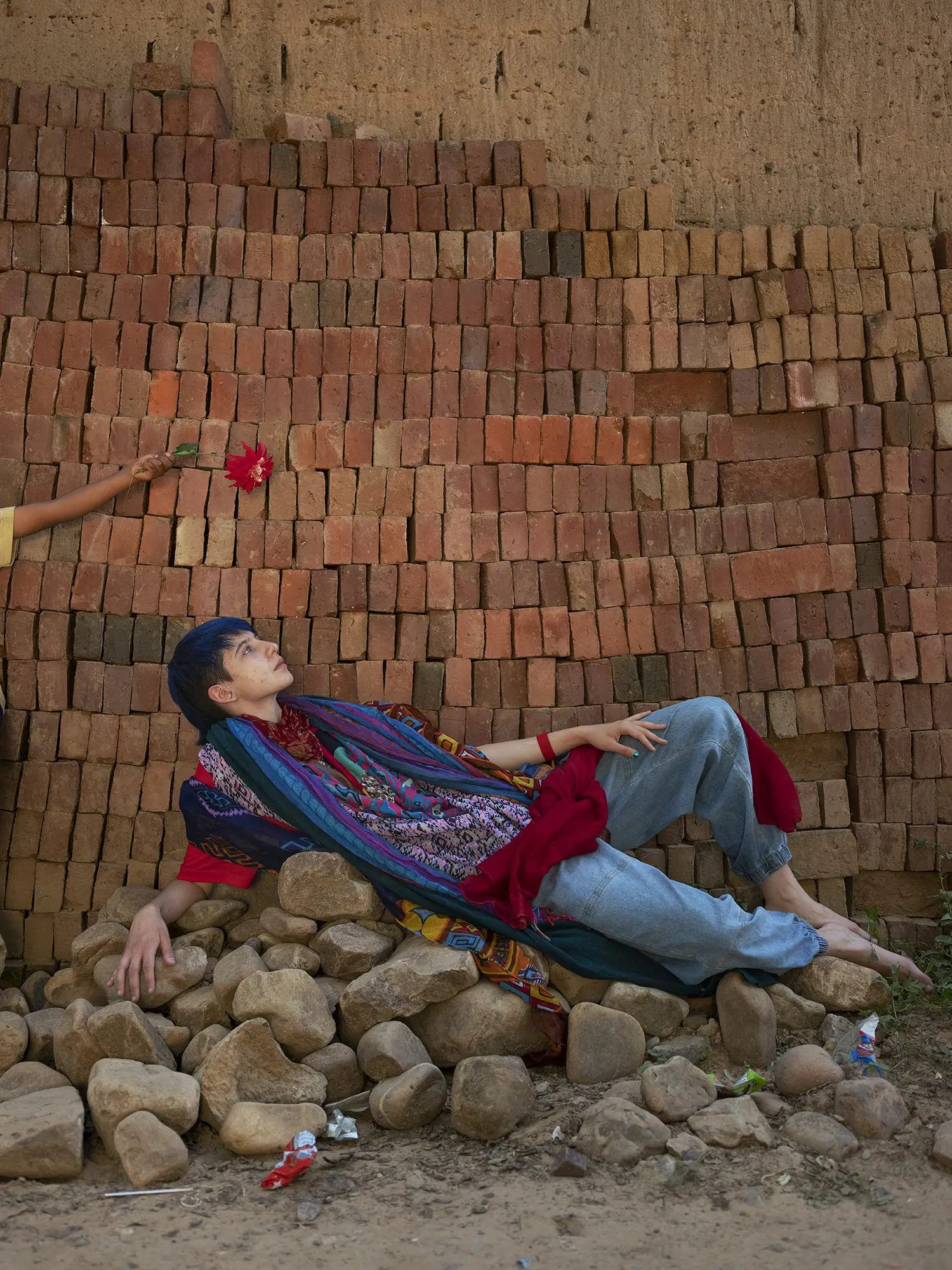 Tam lays on a pile of rocks