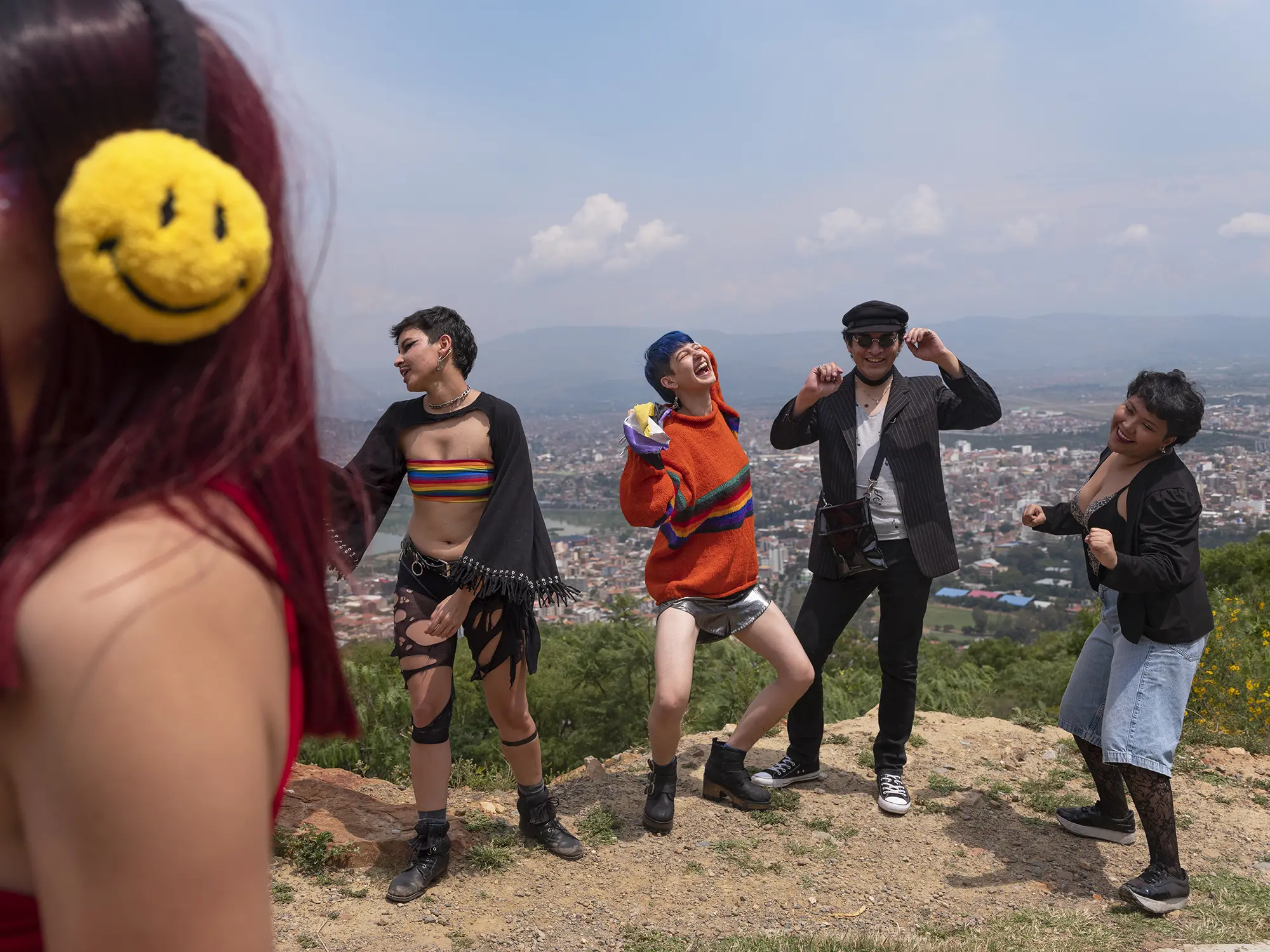 Tam dances on a mountain with other young people