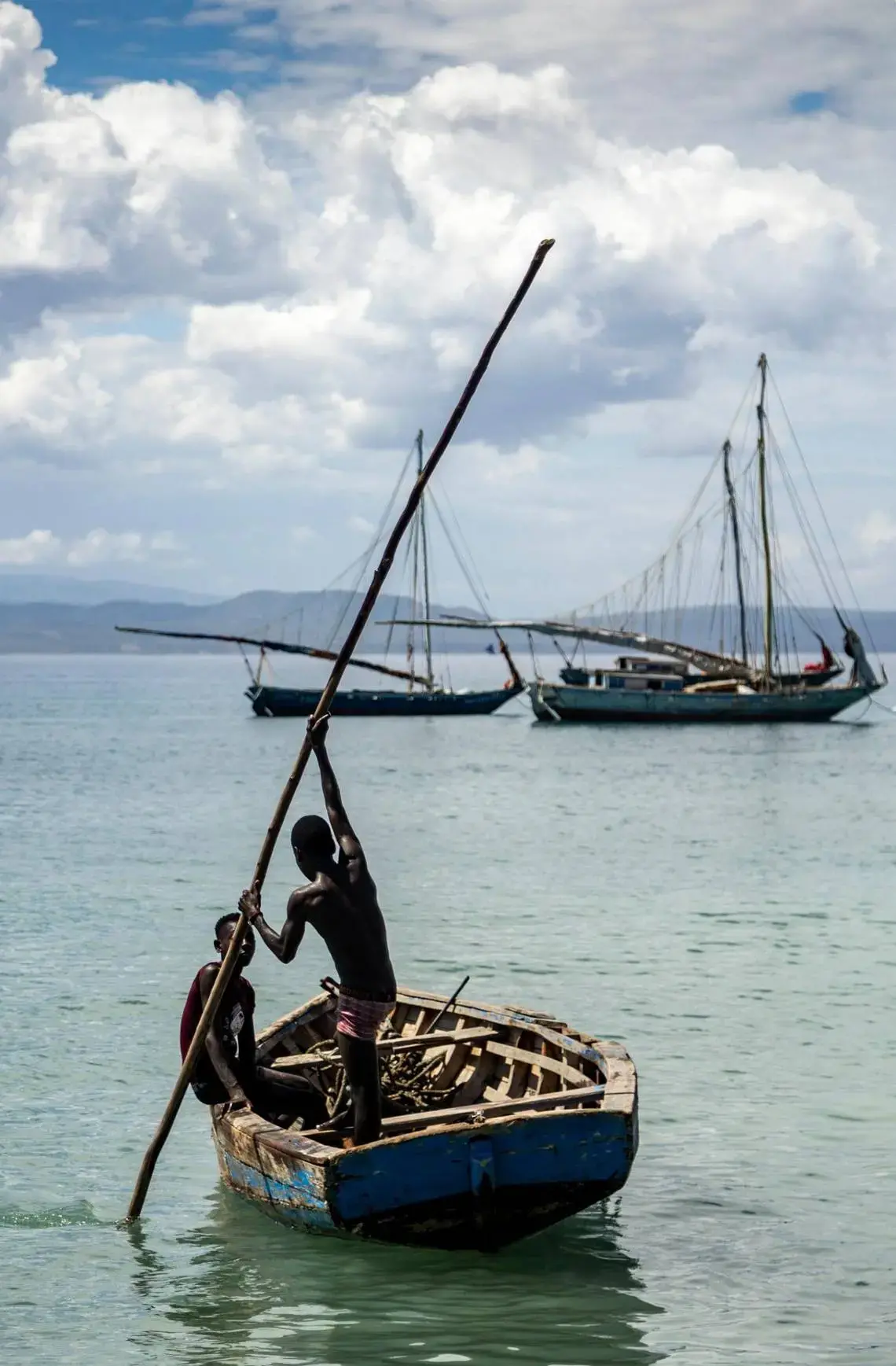 To young boys start a paddling a boat