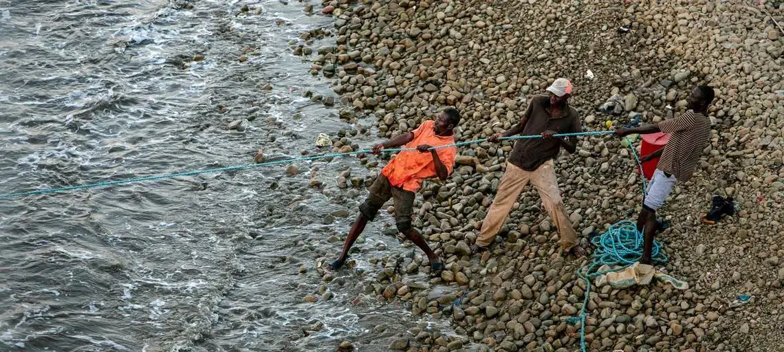 Men pull in a fish net