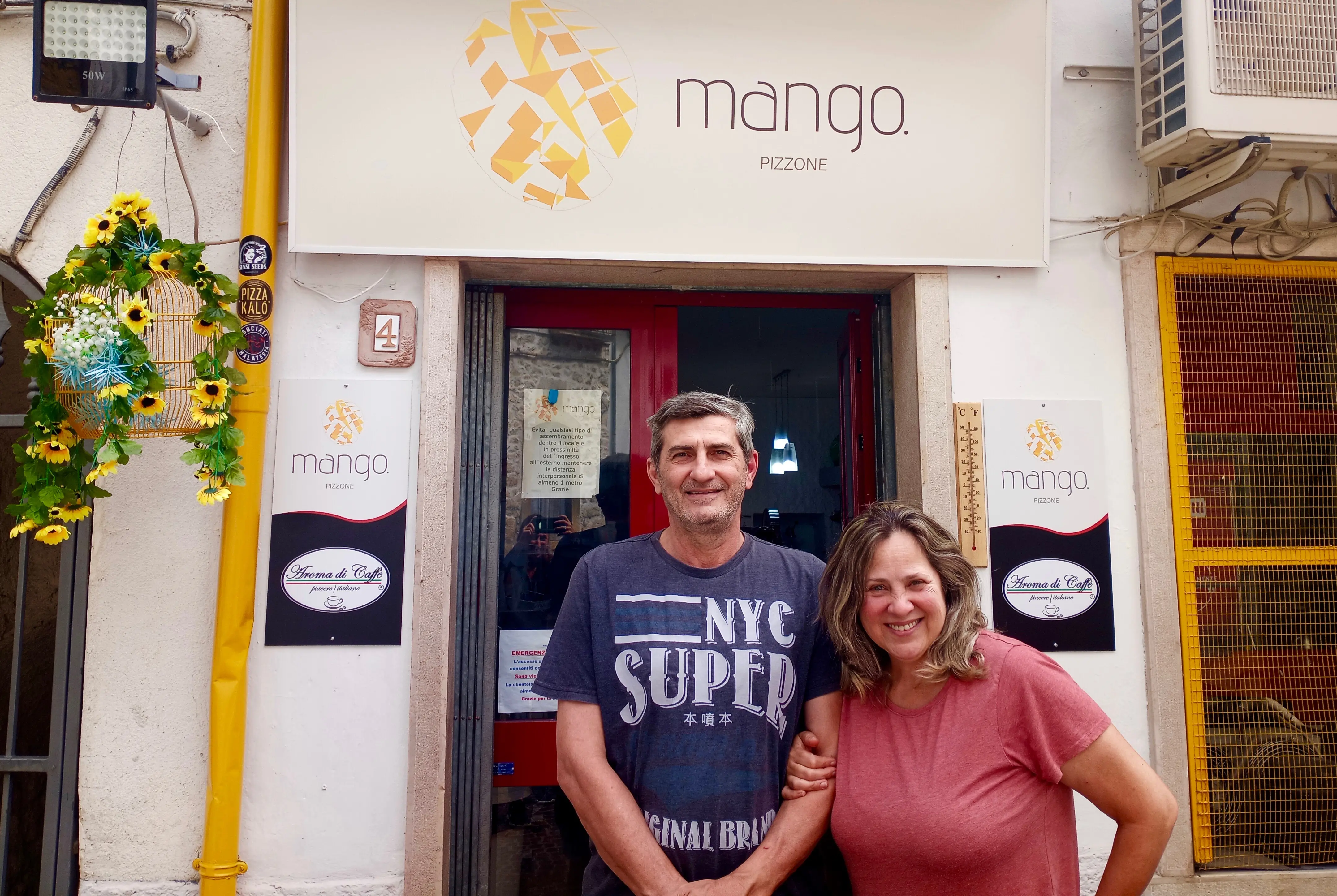 A couple in front of a business and bar they opened