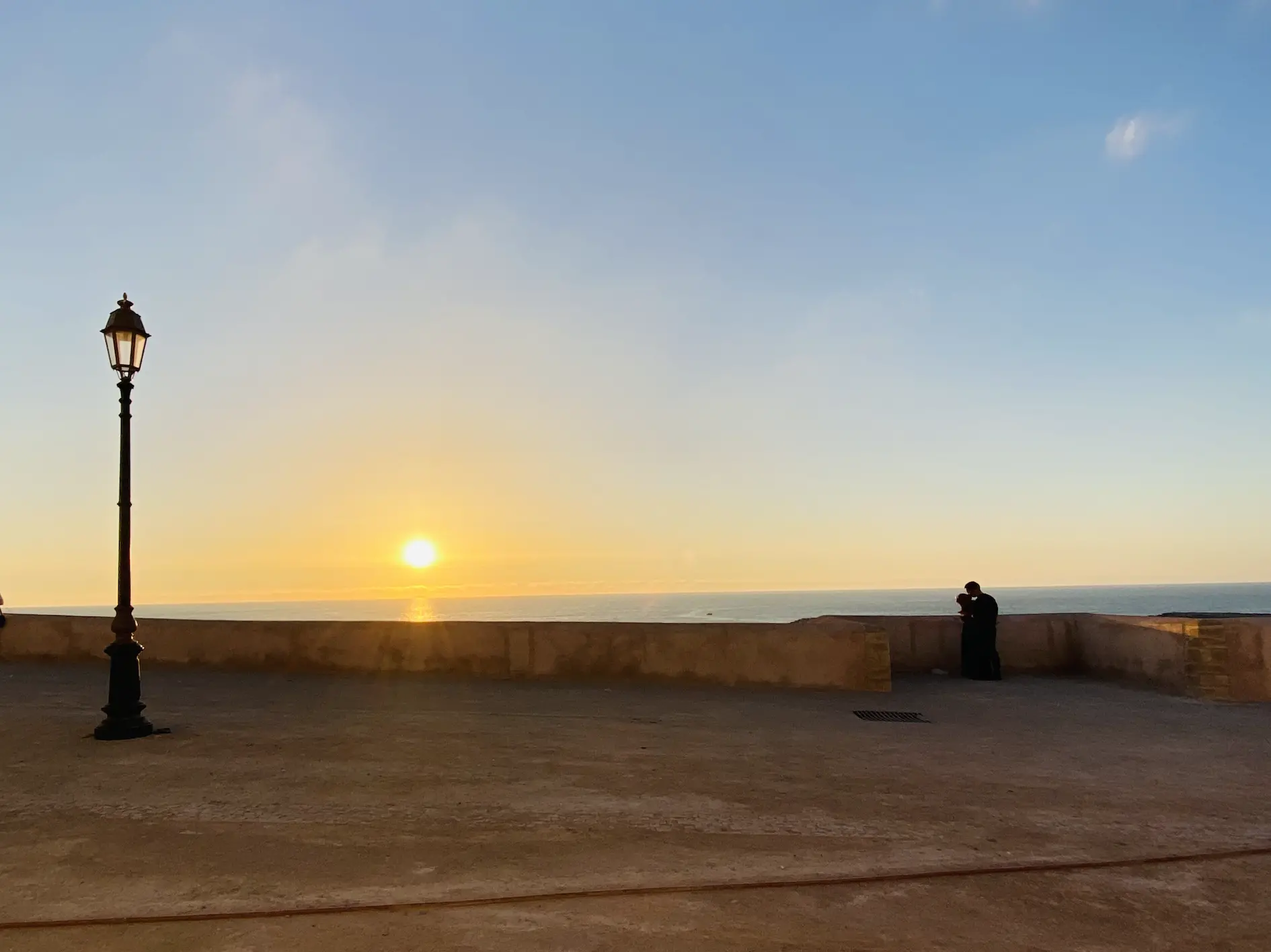 plaza with view of water and sunset