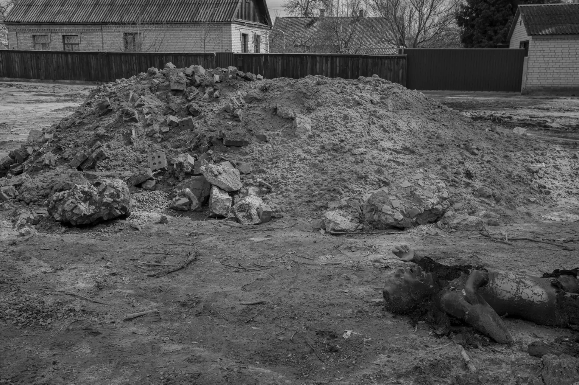 One of several corpses reported to have been brought by Russians on a tank, dumped, and set on fire.
