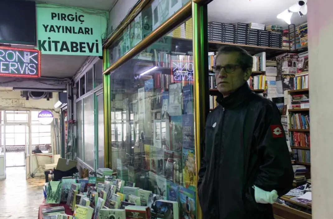 Man stands in front of bookstore