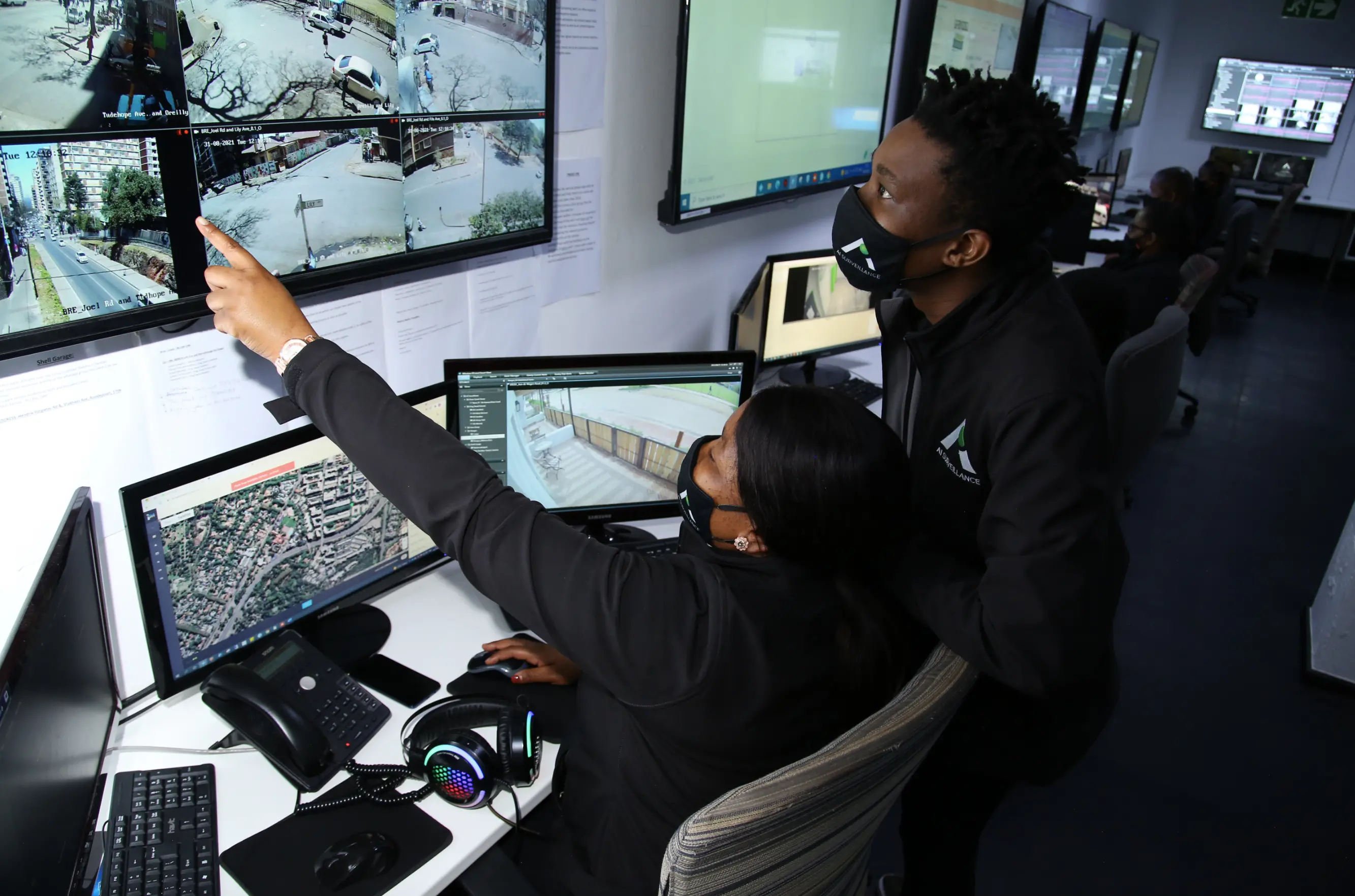 Woman points at screen to surveillance
