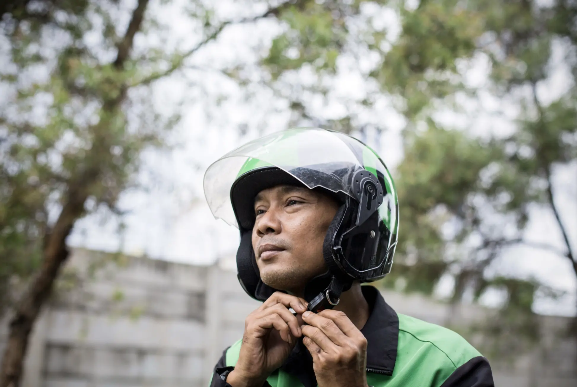 a man buckles his helmet 