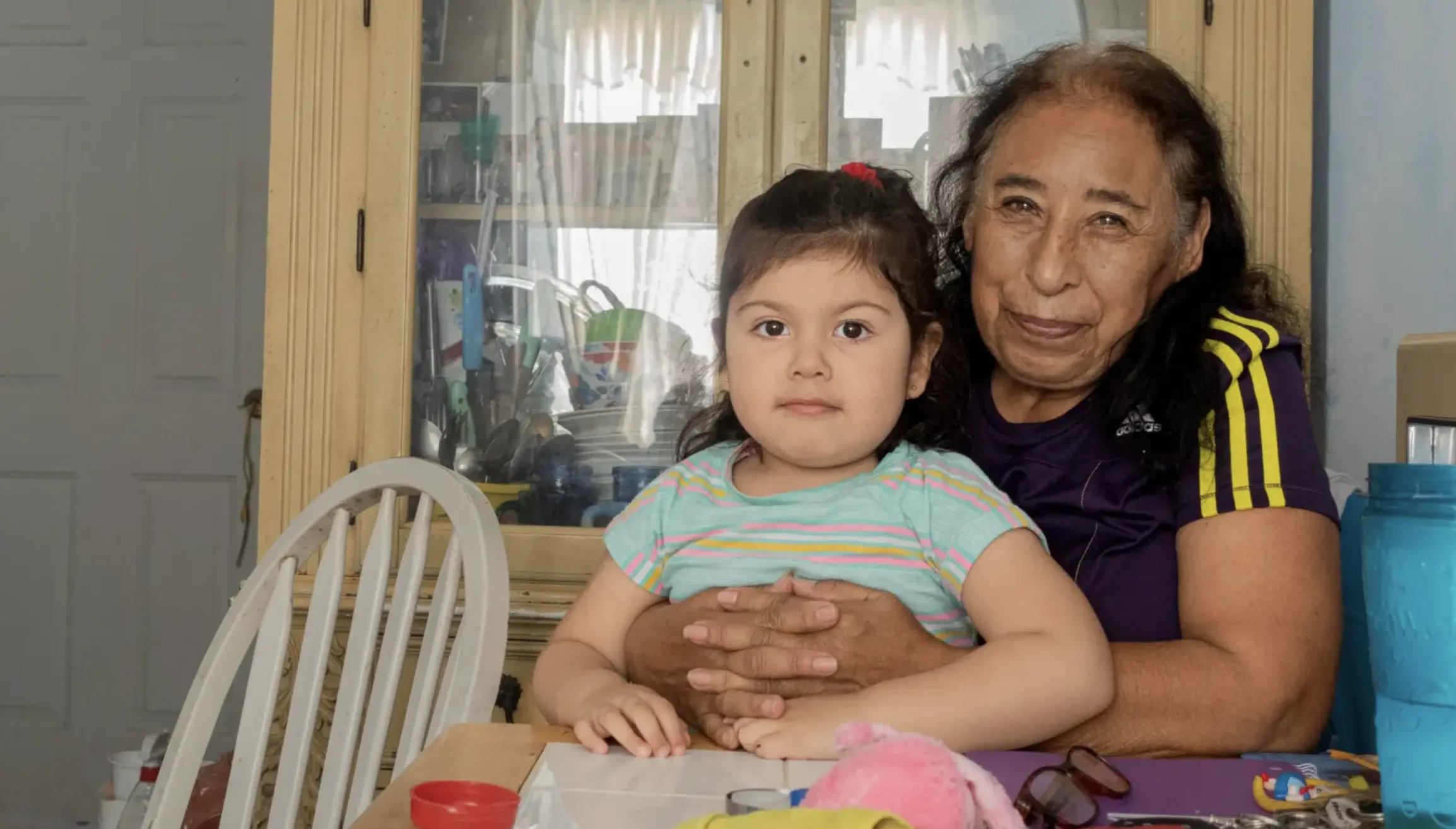 A grandmother sits with granddaughter on her lap<br />
