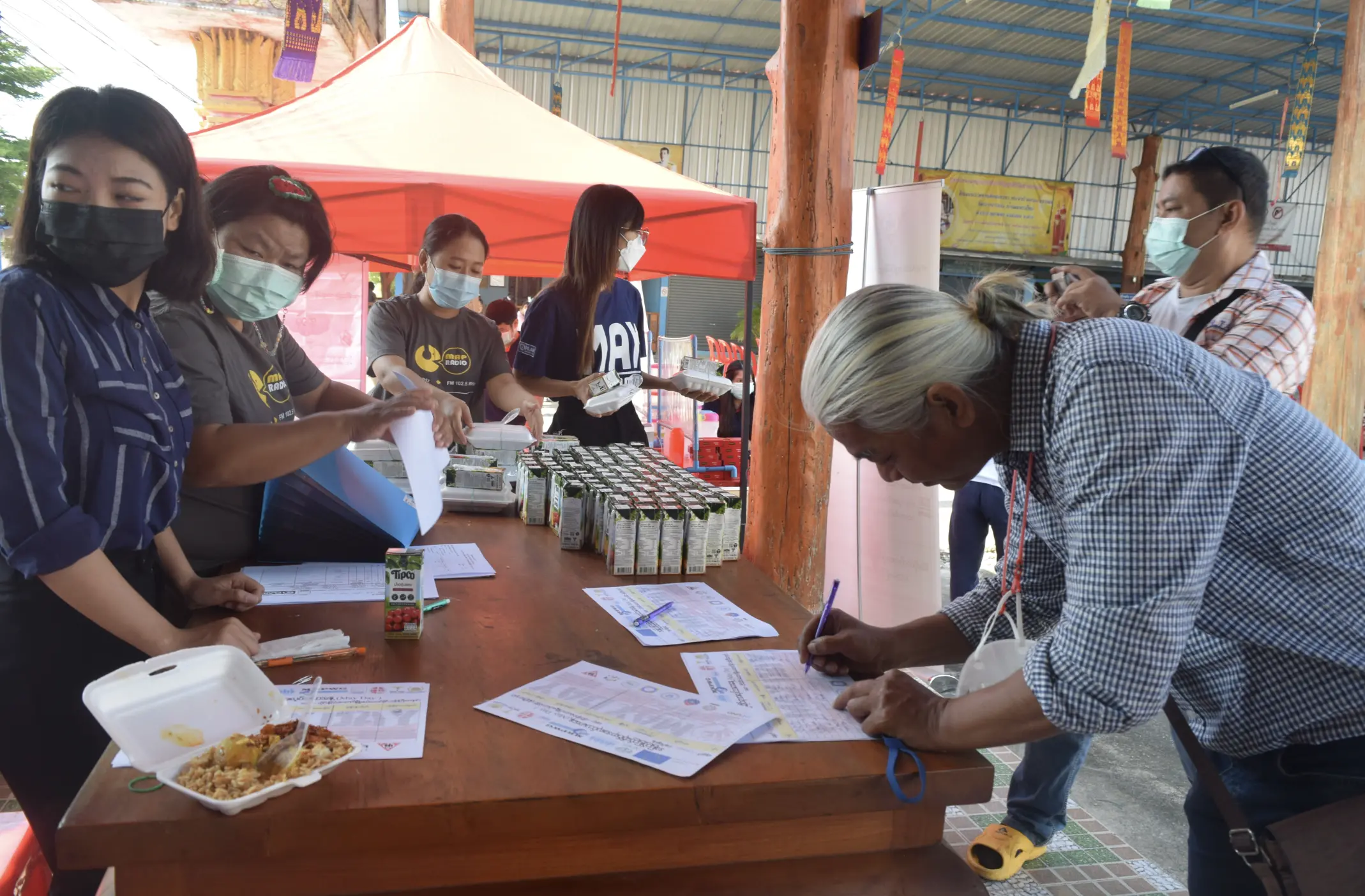 A man fills out a form with a NGO that works to avoid exploitation