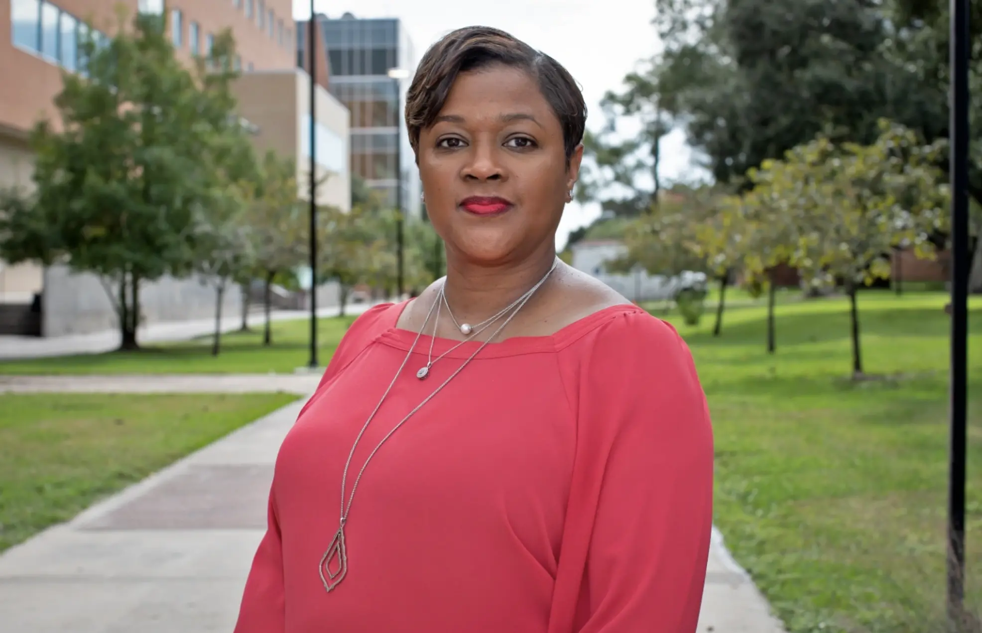 A woman poses for a headshot at a university in Texas