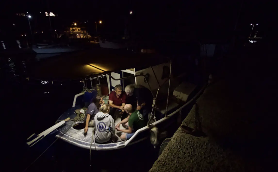 fishermen on boat at night