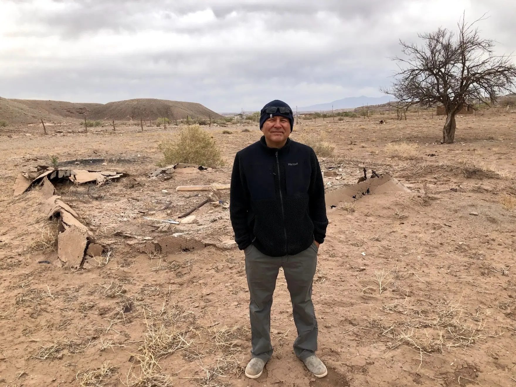 man stands in front of area where is home used to be