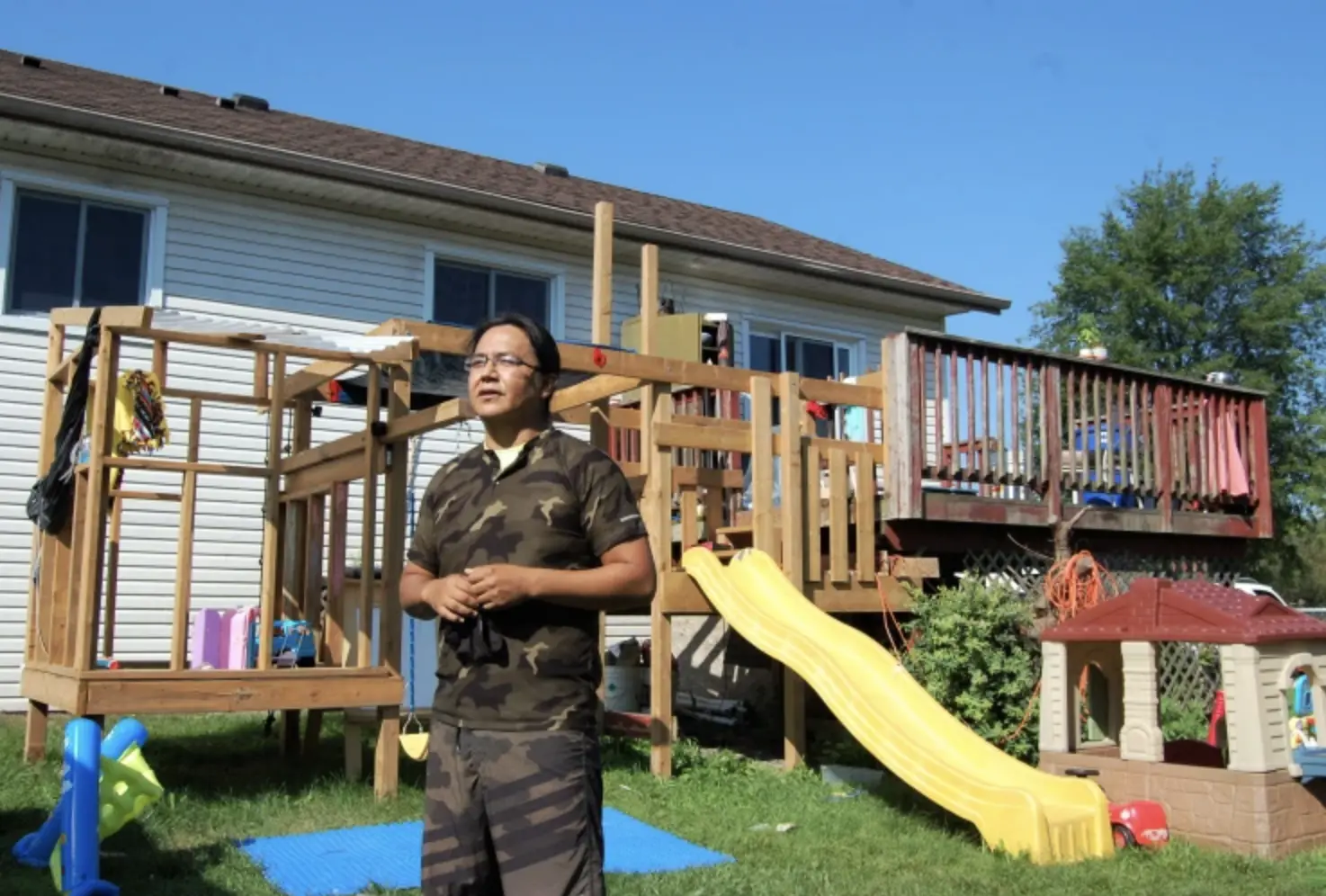 Man stands in front of house