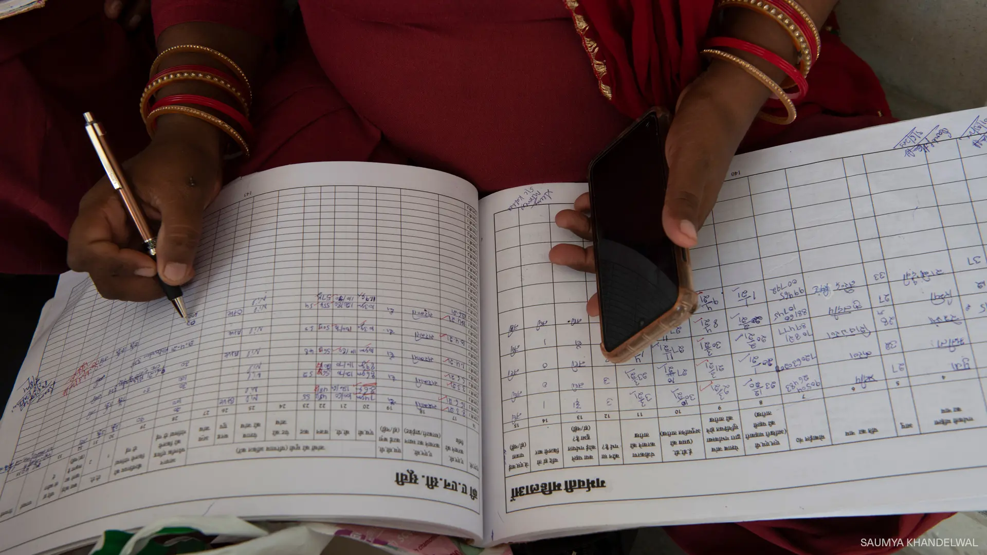 A woman writing down hand records