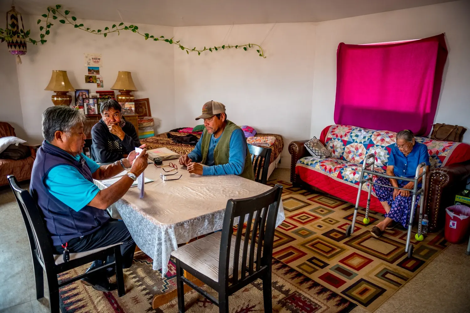 Phil Harrison, Paul Denetdeal and Bobby Robbins sit at a table. Image by Mary F. Calvert. United States, 2020.