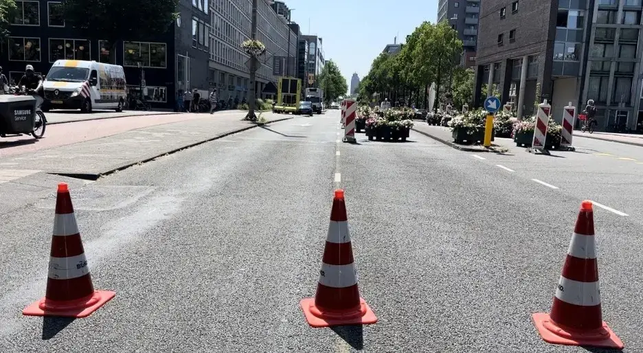 three orange traffic cones in the street, Amsterdam