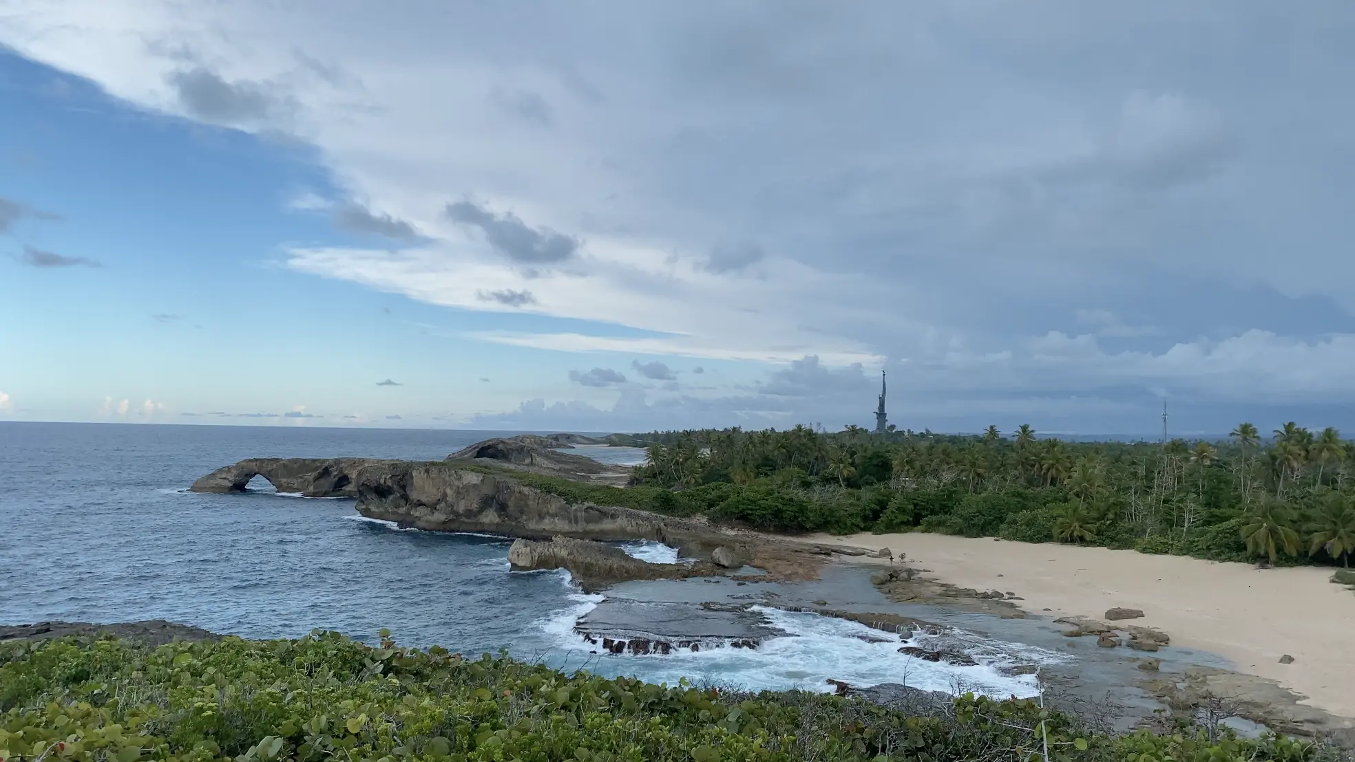 A 360 foot (110m) tall statue of Christopher Colombus looms over the horizon in the northern coastal town