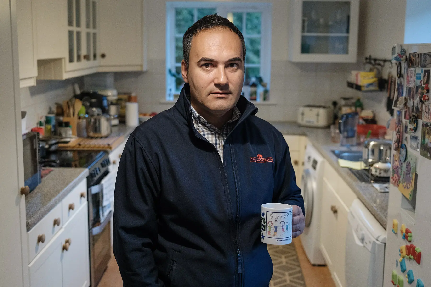 man holds a coffee cup