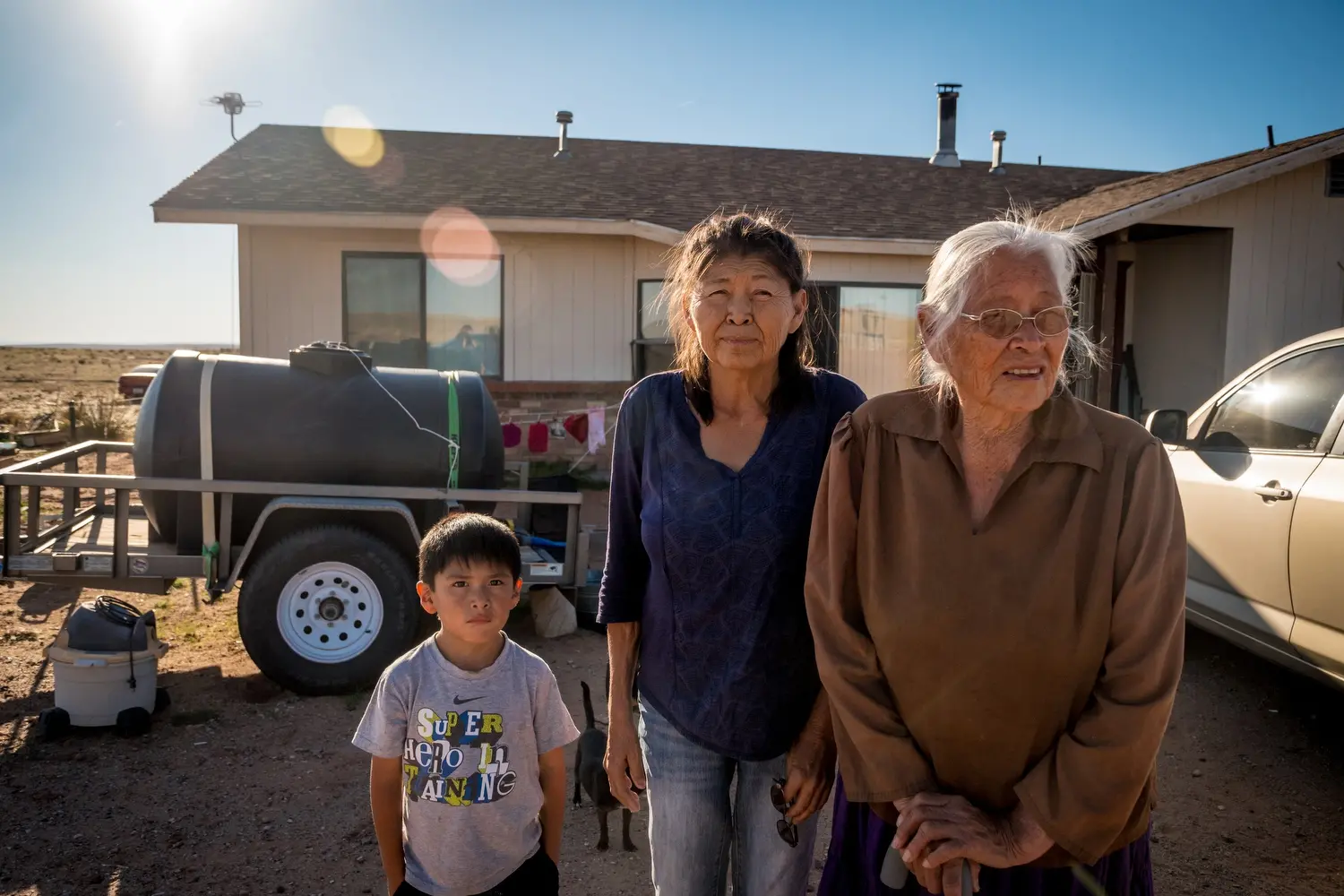 Cecilia Joe, her daughter Augusta Gillwood and Ryan Joe Jr. at their home near Tuba City. Image by Mary F. Calvert. United States, 2020.